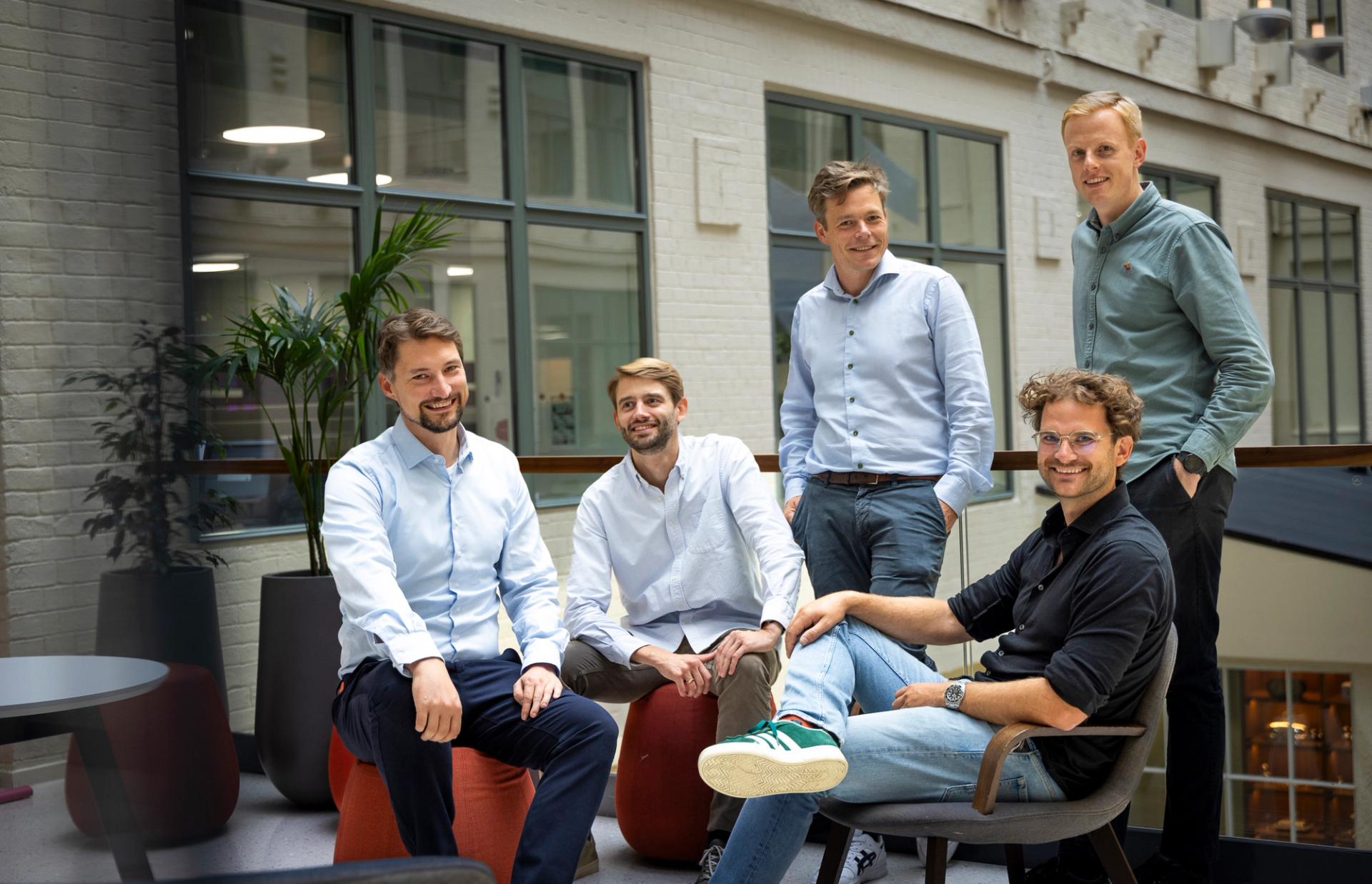 Five young white men in button-down shirts