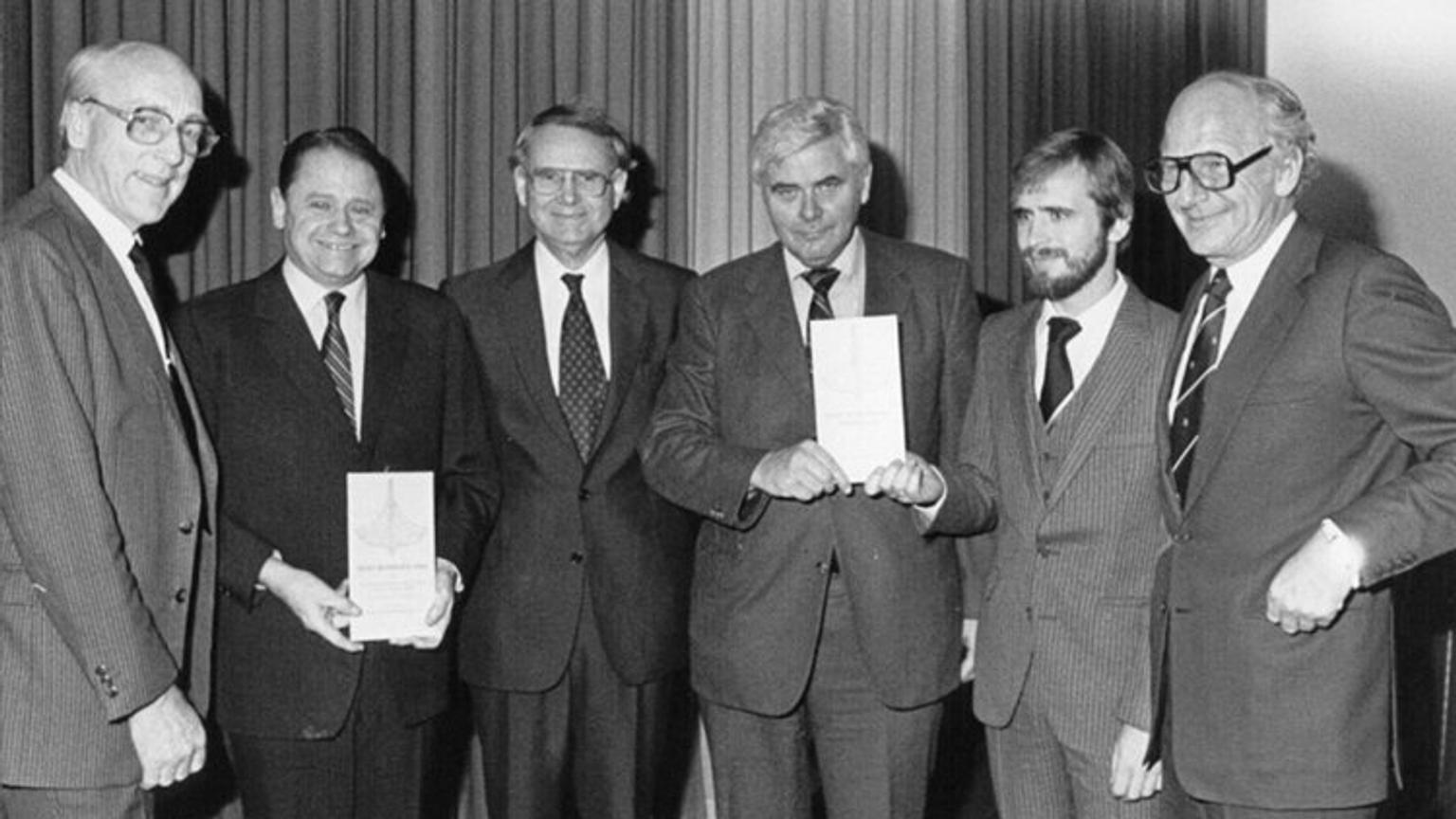 Group of men receiving award