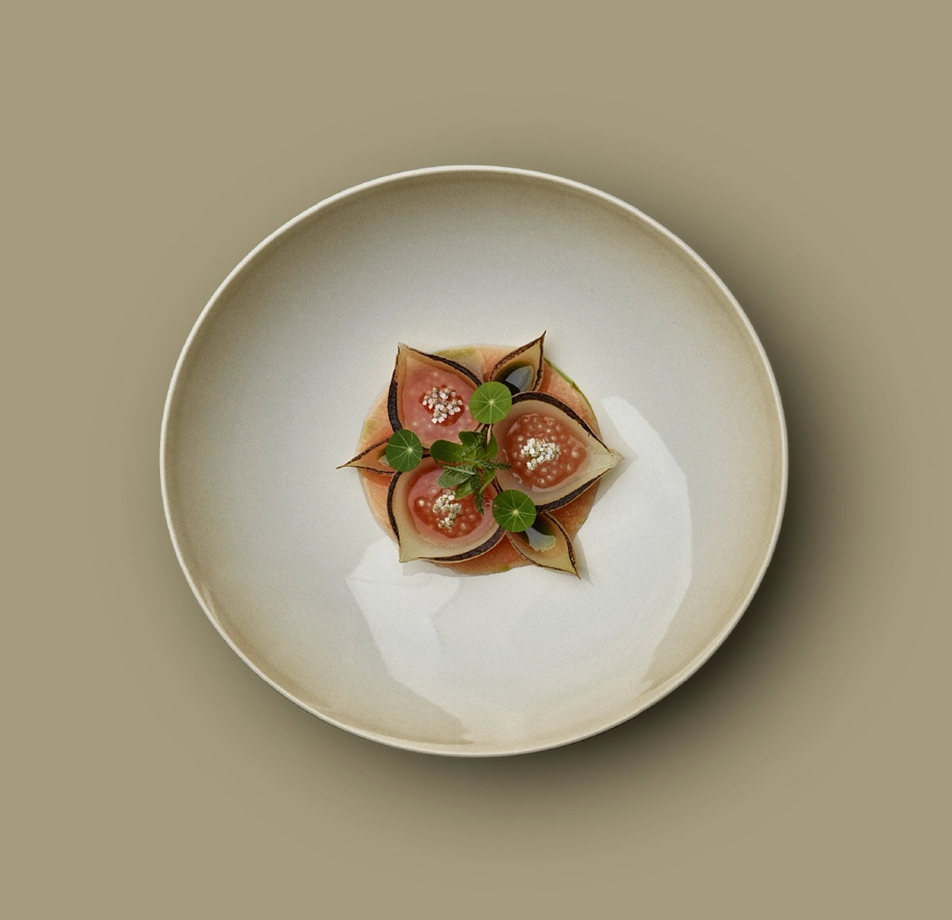 Beige ceramic plate with cut, fresh figs
