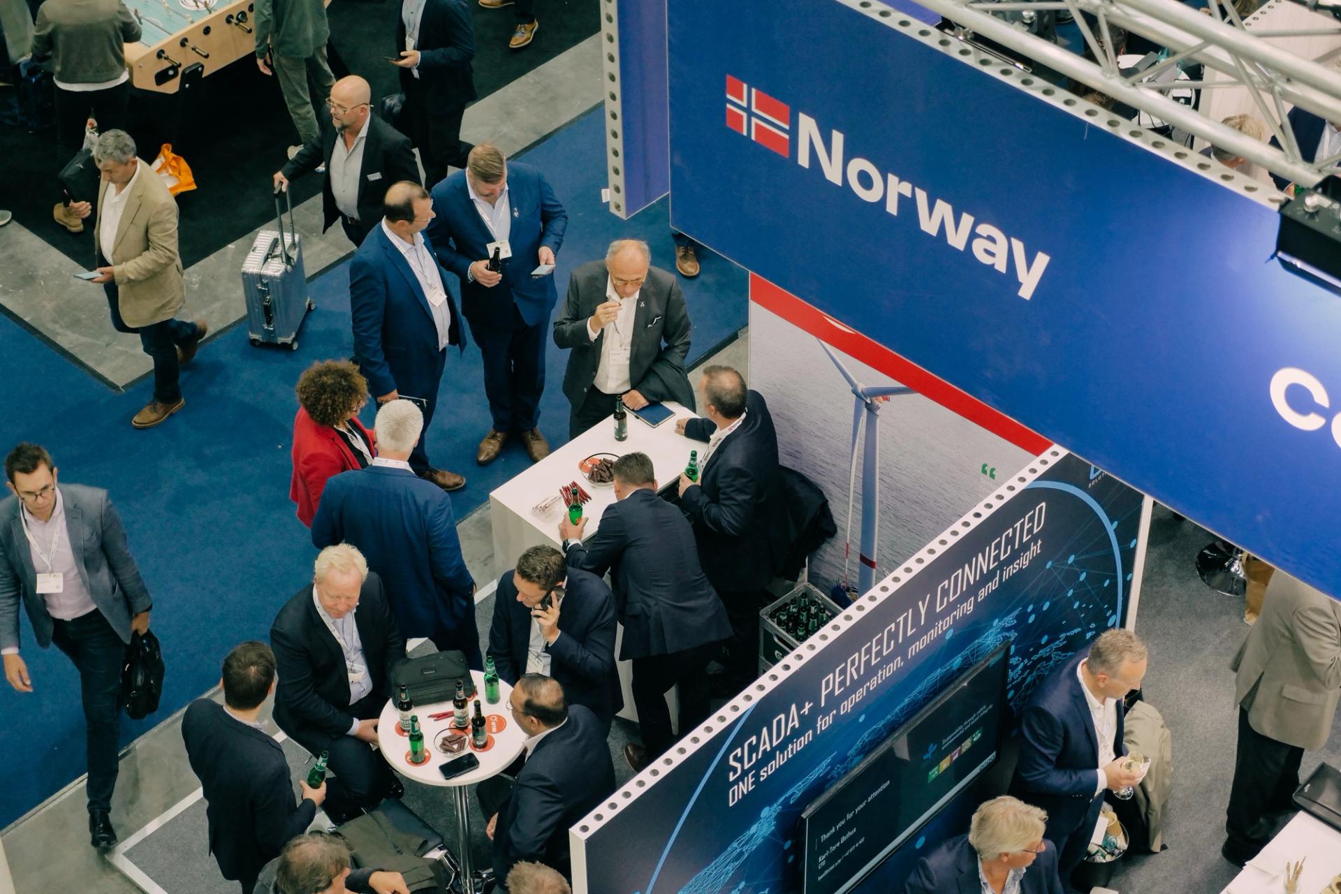 Overhead shot of people standing at a Norway Pavilion at a conference