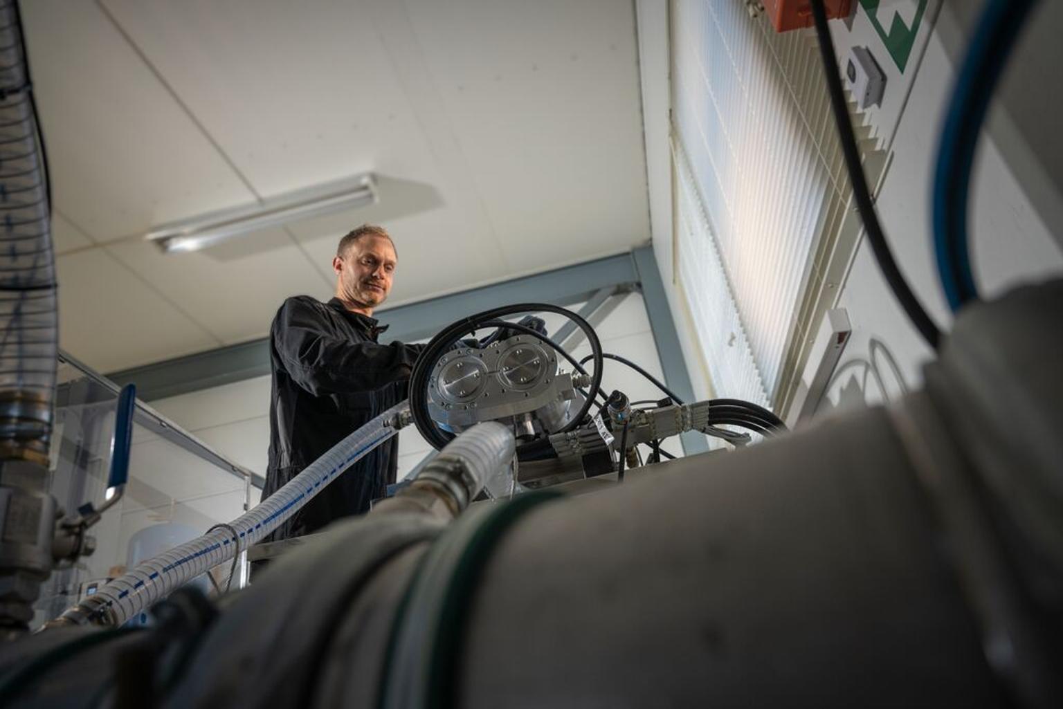 Portrait of a man working with a hydrogen compressor