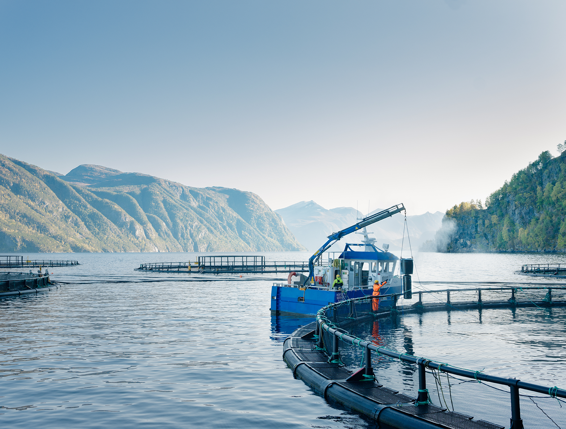 Fish farm with boat in fjord