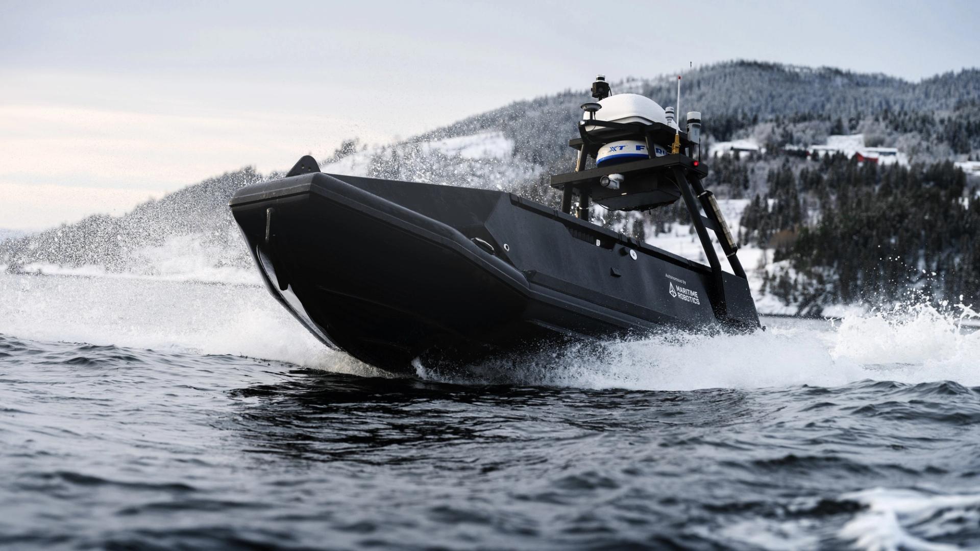 A black unmanned vessel driving at top speed