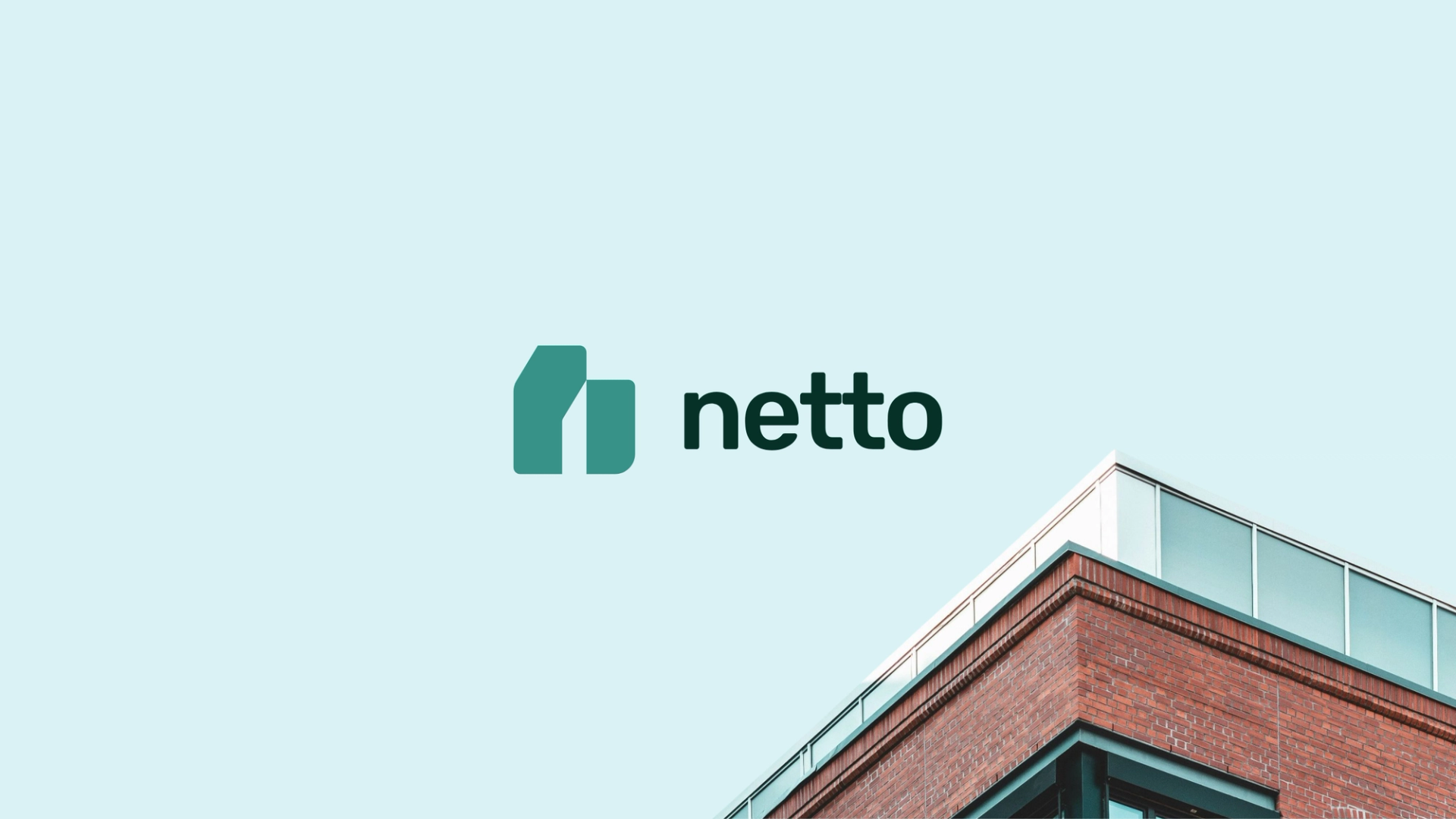 Corner of a brick building with the company name Netto floating in the air