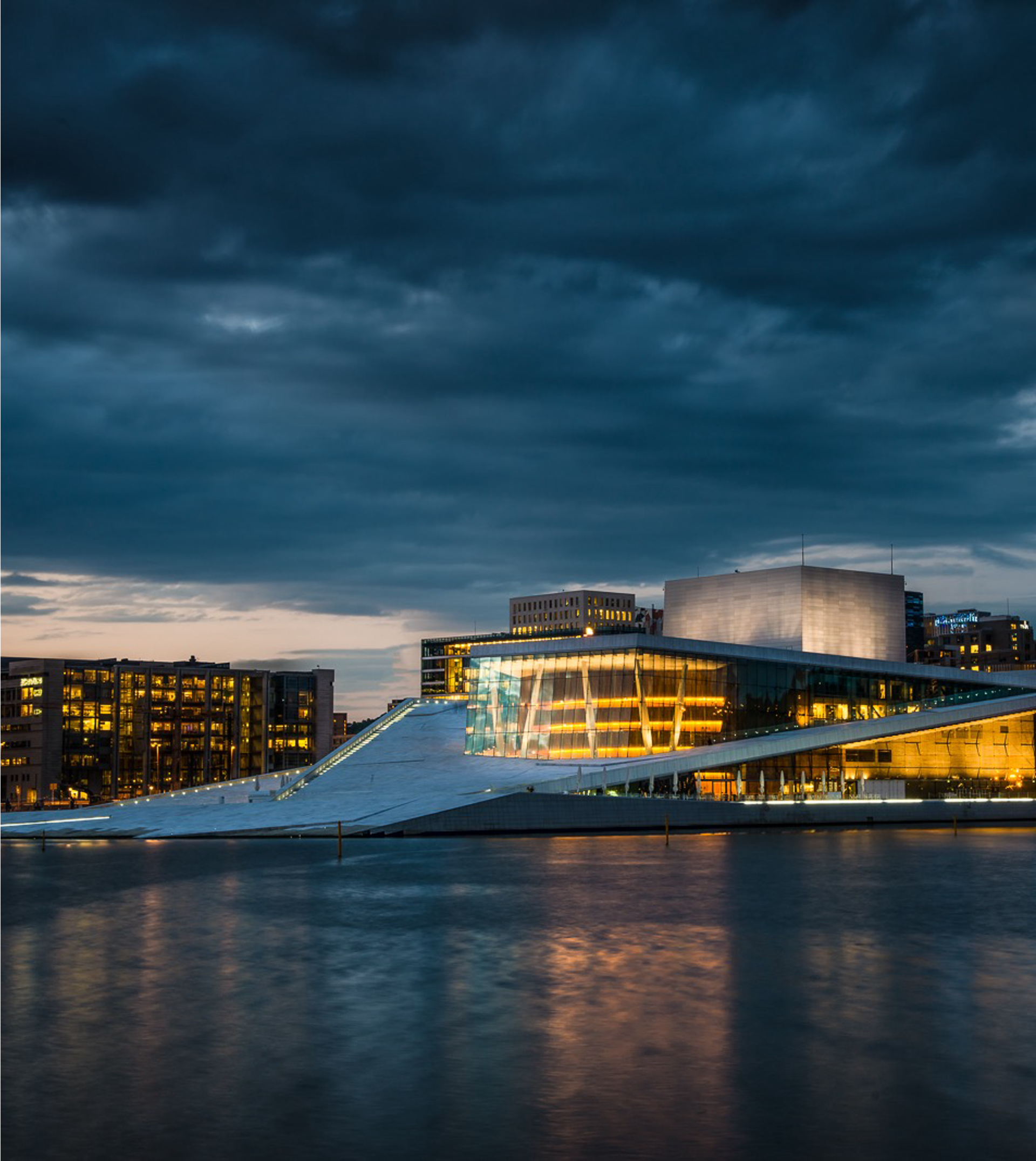 The Oslo Opera House lit up at night.