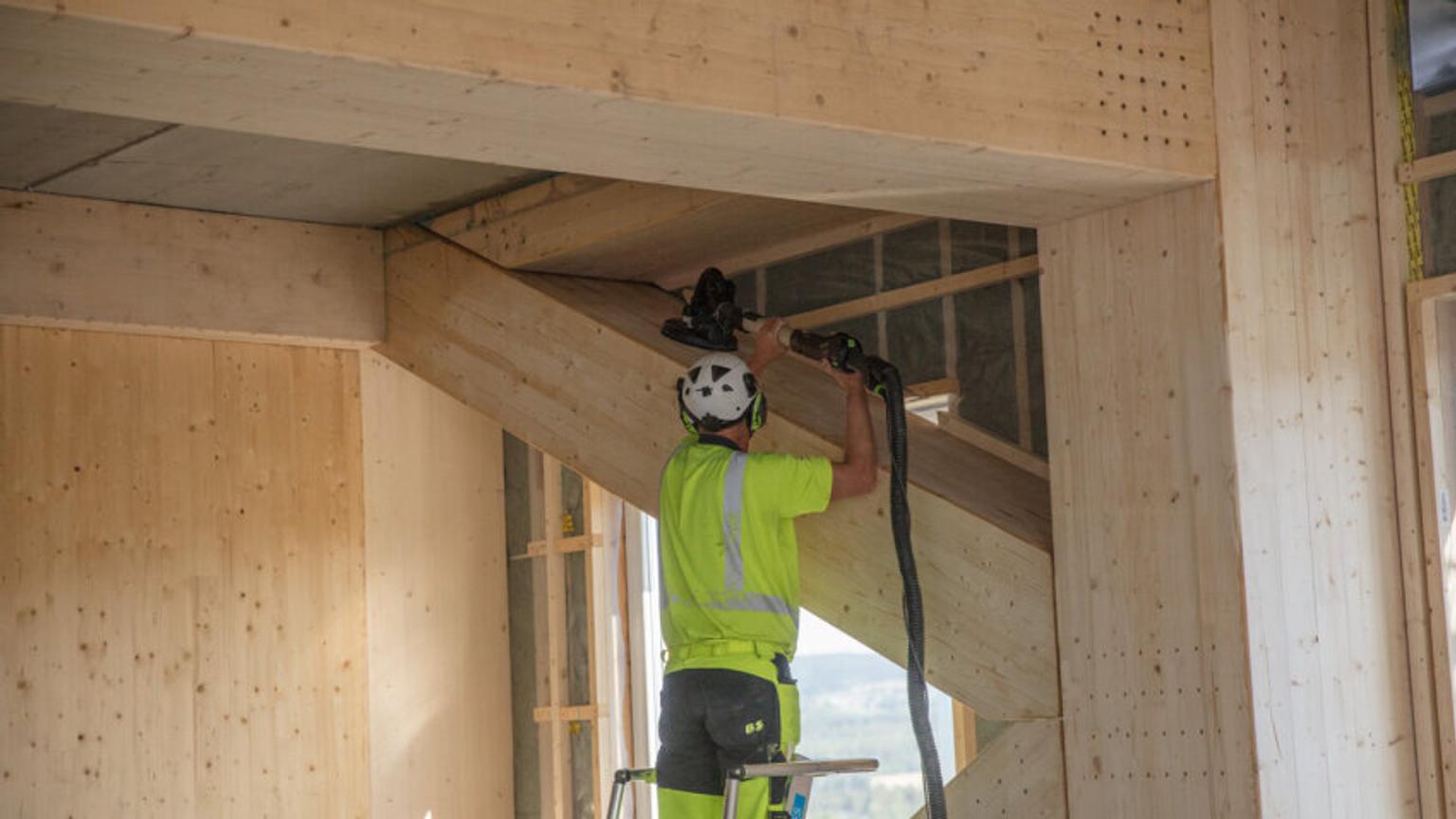 Person working with wood inside building