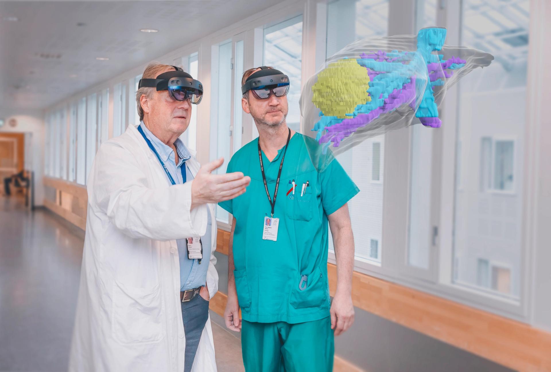 Two employees at the hospital looking at a hologram of organs.