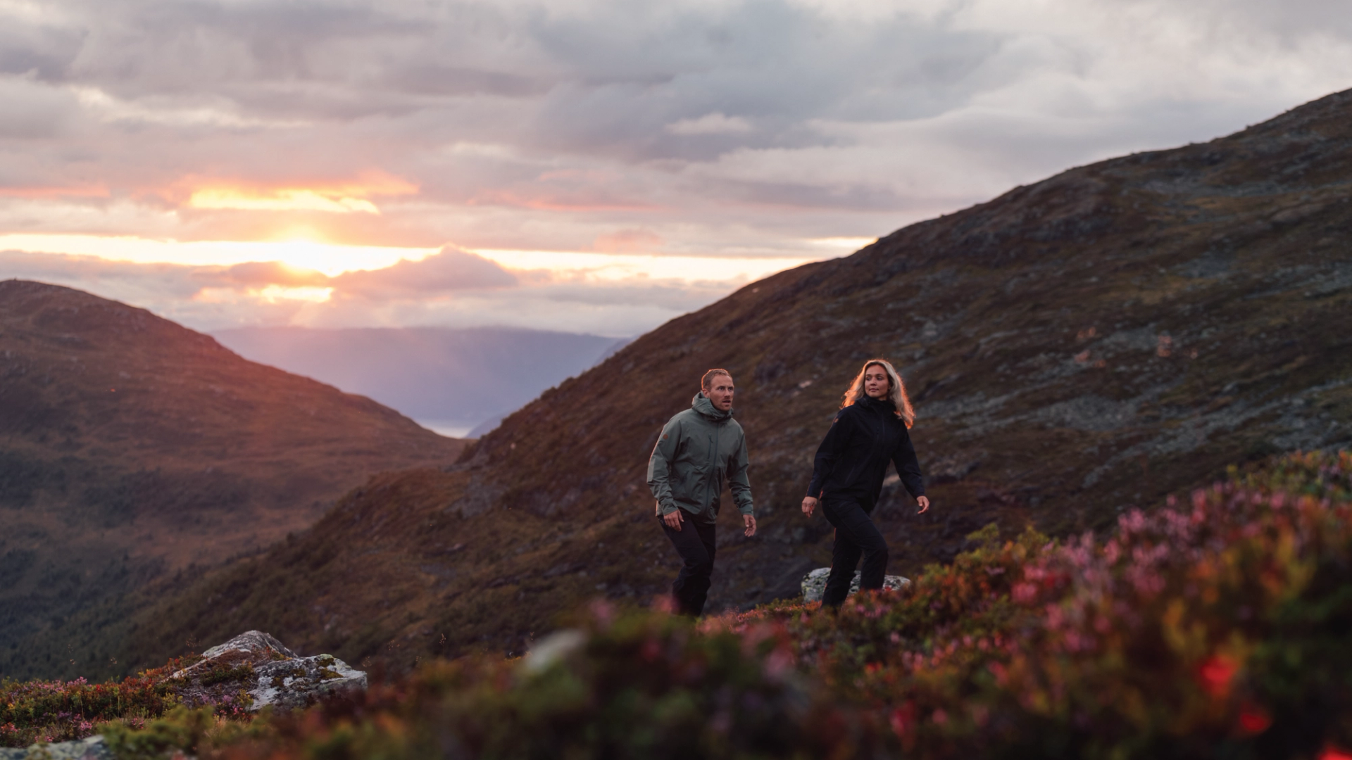 A man and a woman hiking in the mountains