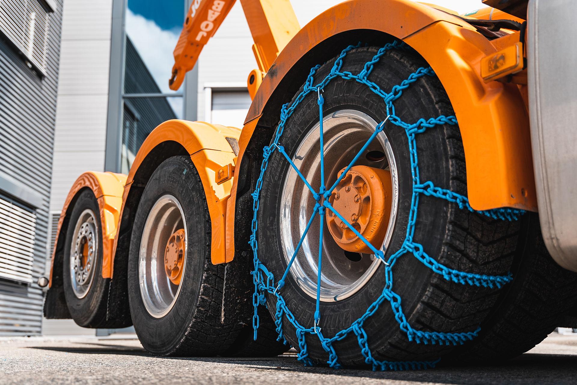 Blue chains on a truck tires.