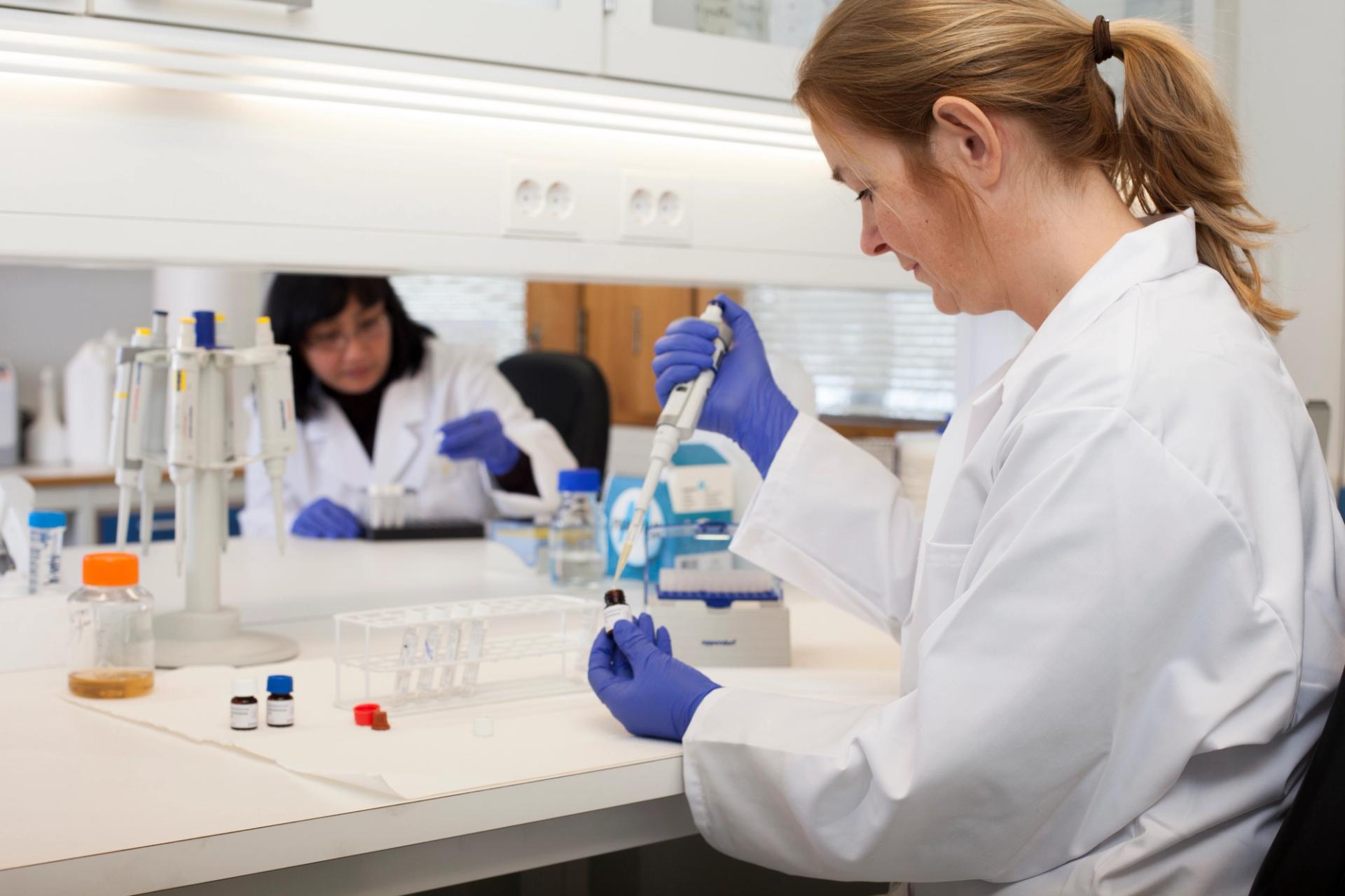 woman in white lab coat working in a laboratory