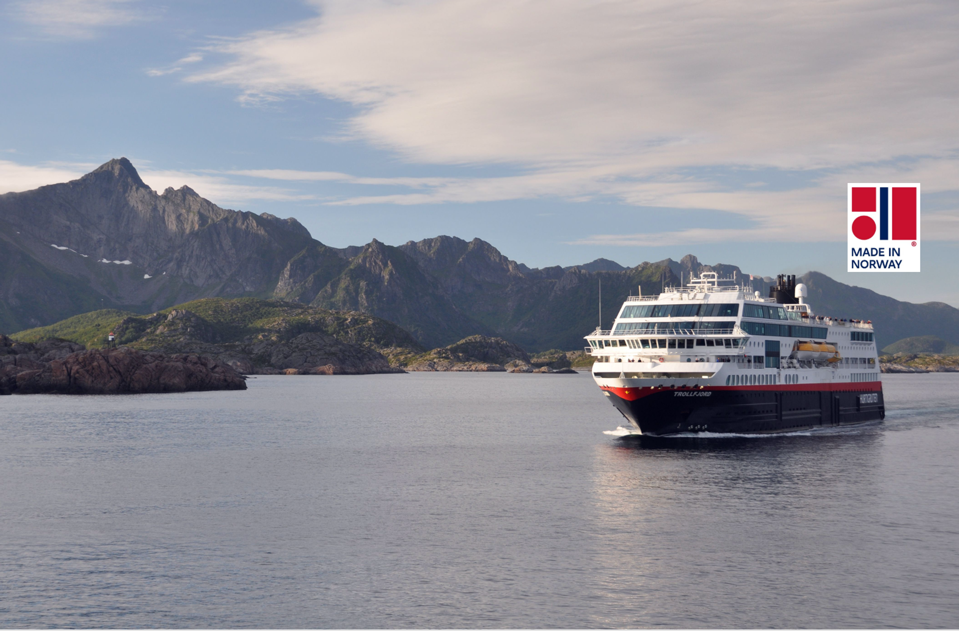 Cruise ship in slow speed through strait surronded by steep mountains
