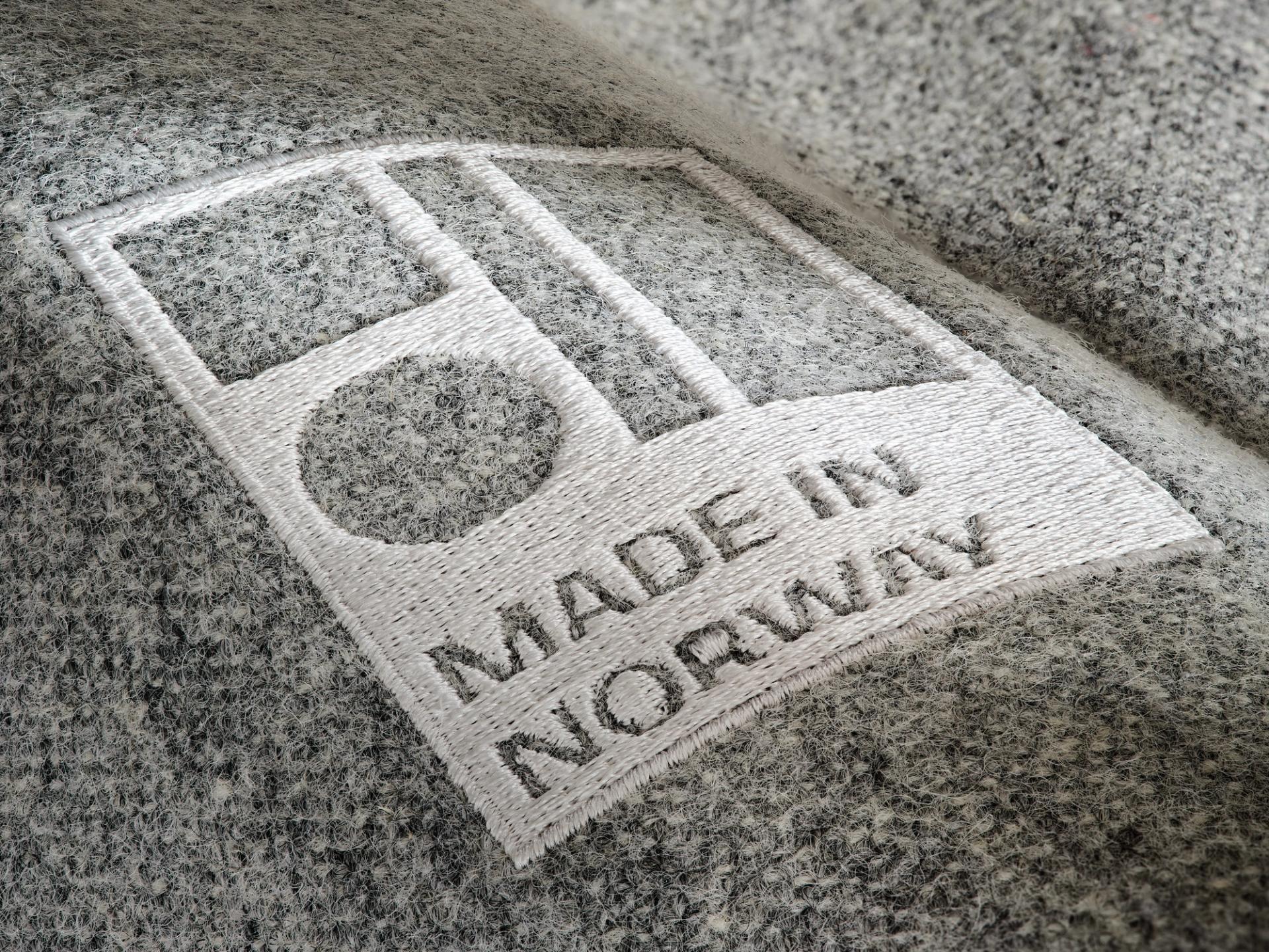 Made in Norway label stitched into grey fabric