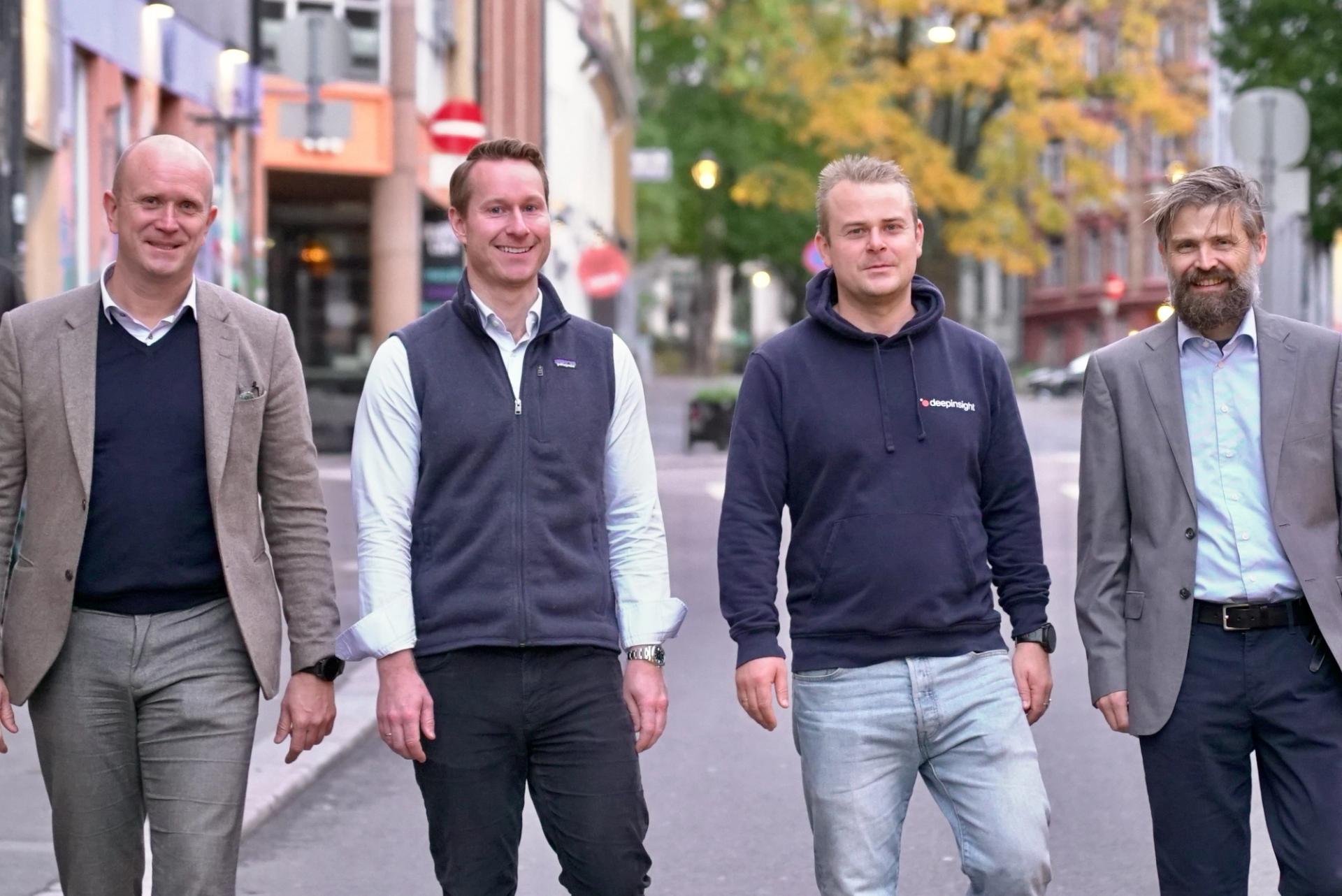 4 men smiling to the camera.