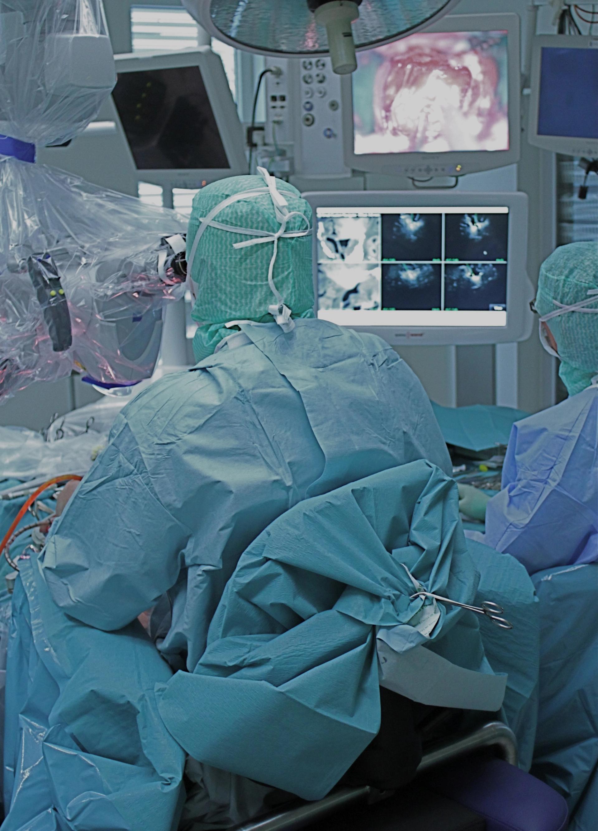 Two doctors performing microsurgical resection