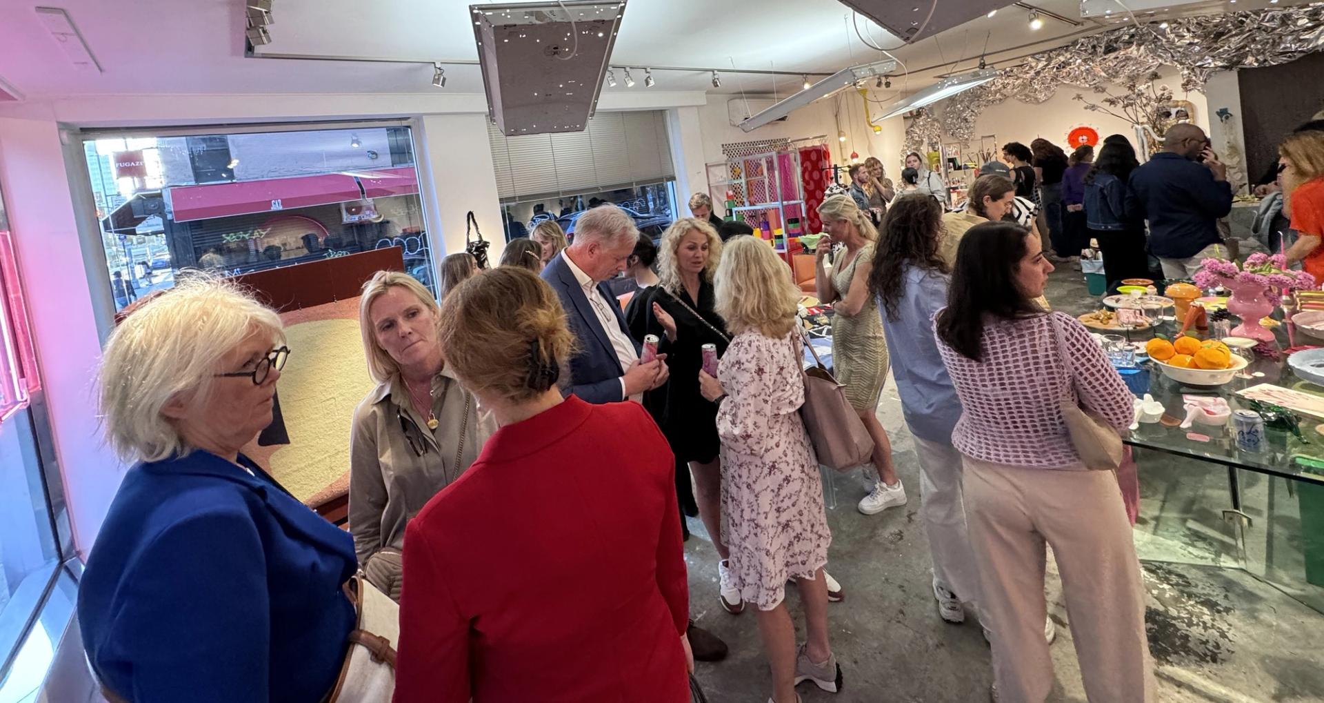 People mingling in a pink-tinged bar