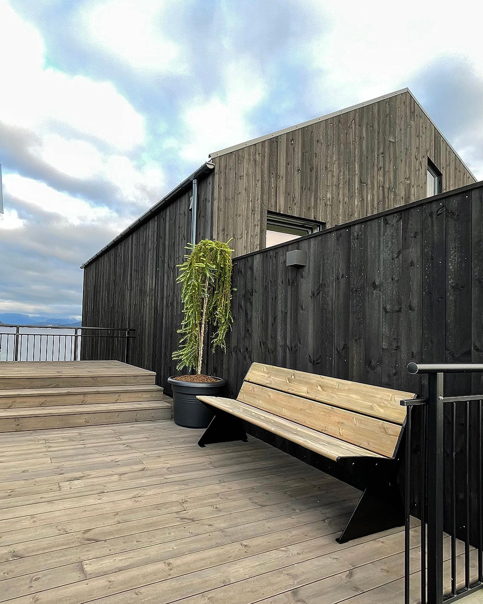 A bench placed outside a house.