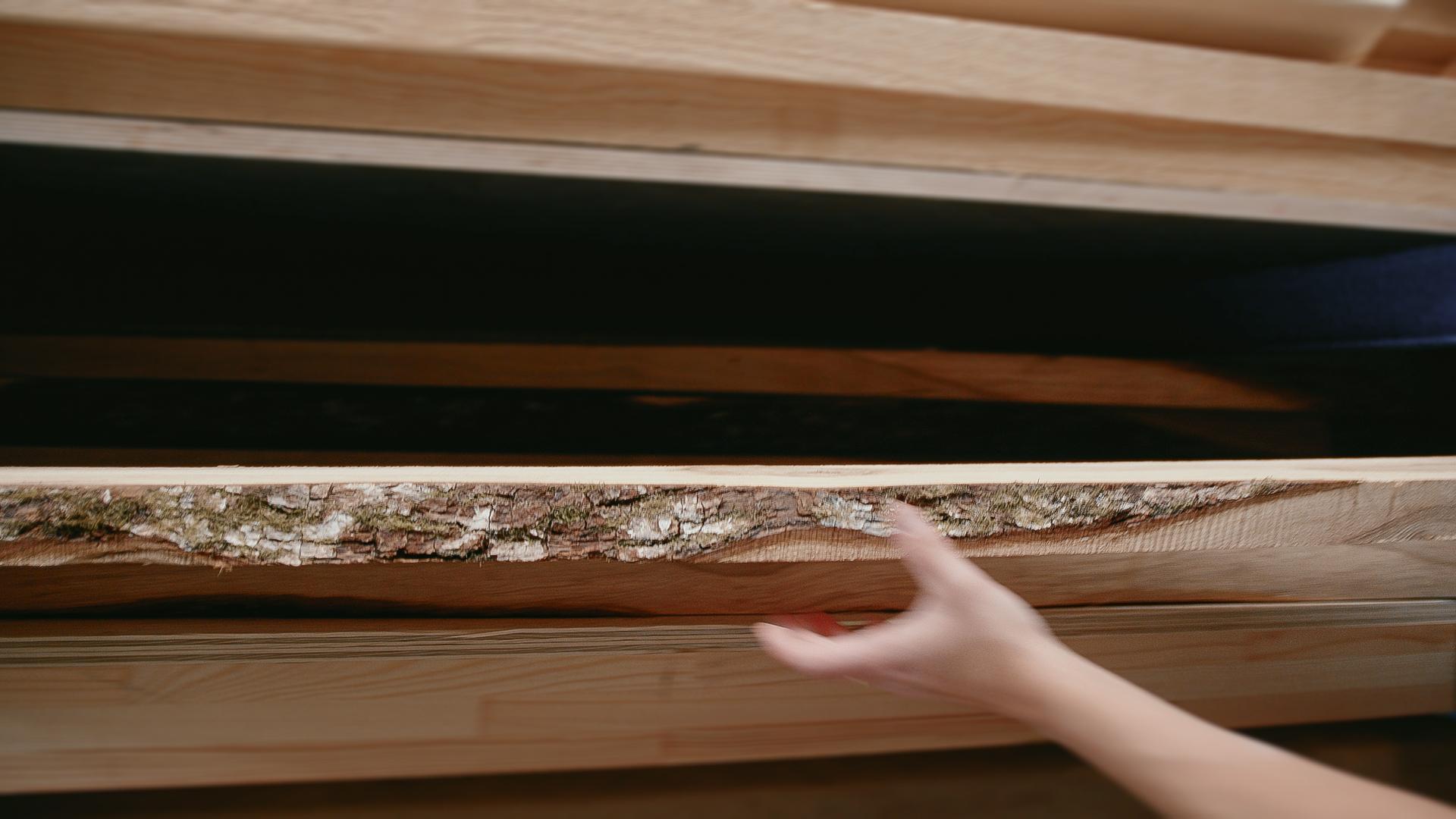 Man's hand reaching for wooden planks