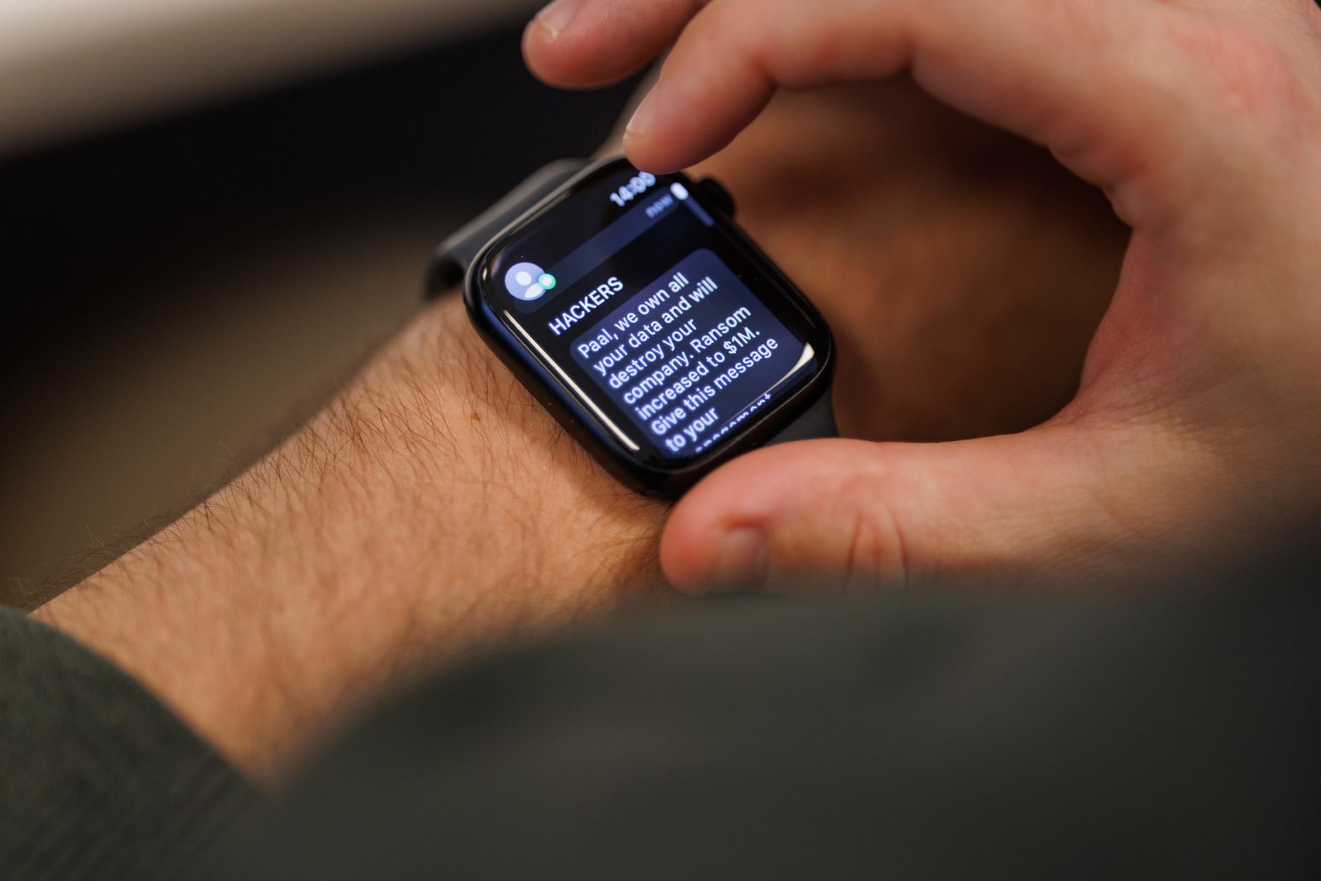 Man checking an email on a black Apple Watch