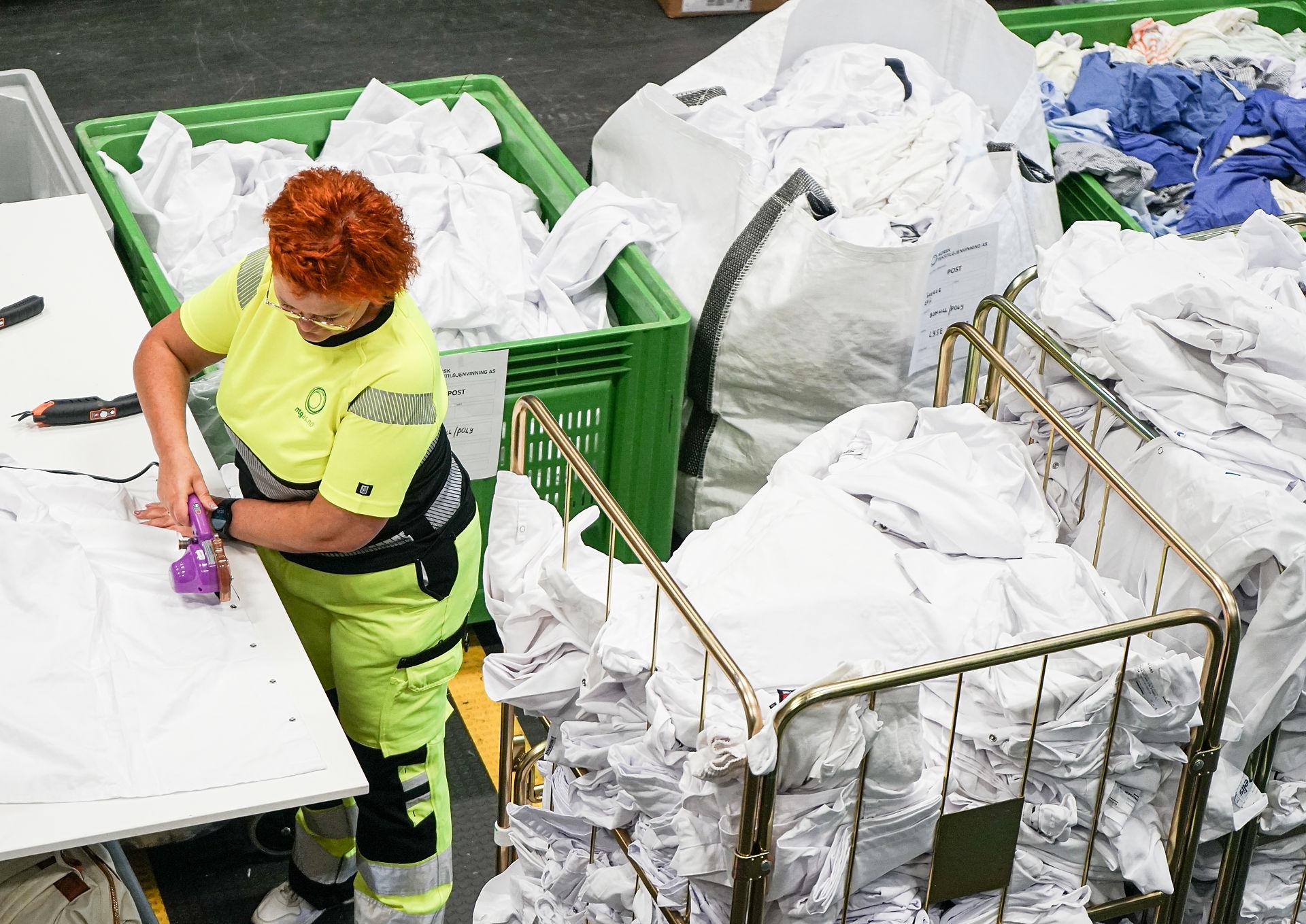 A woman working in a textile recycling fabric.