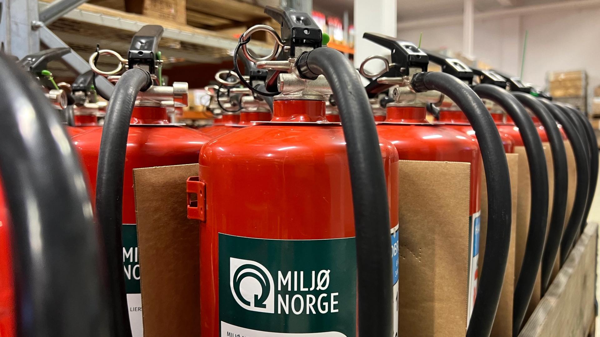 Refurbished fire extinguishers lined up in two rows