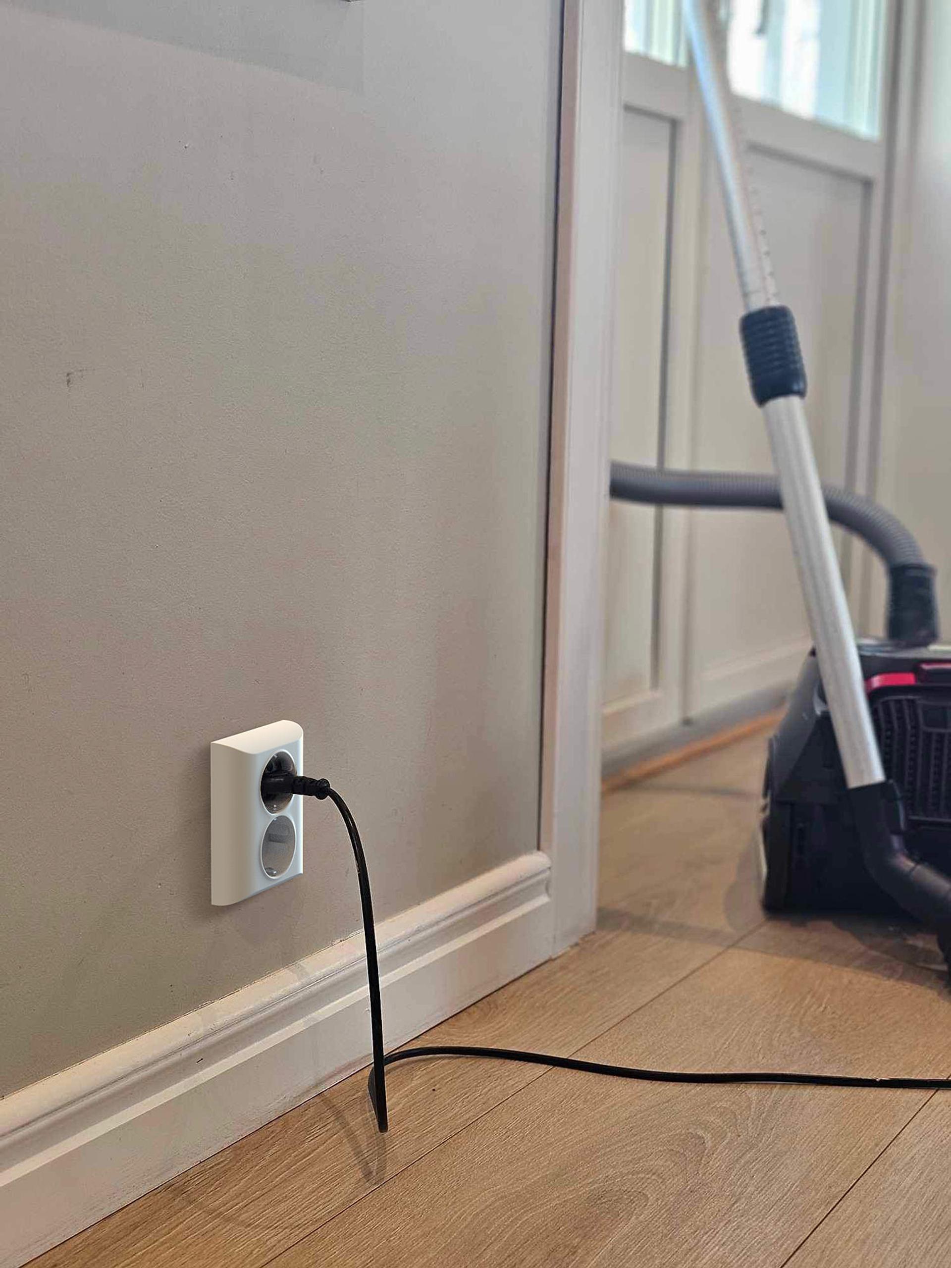 Picture of a white smart socket on a wall.