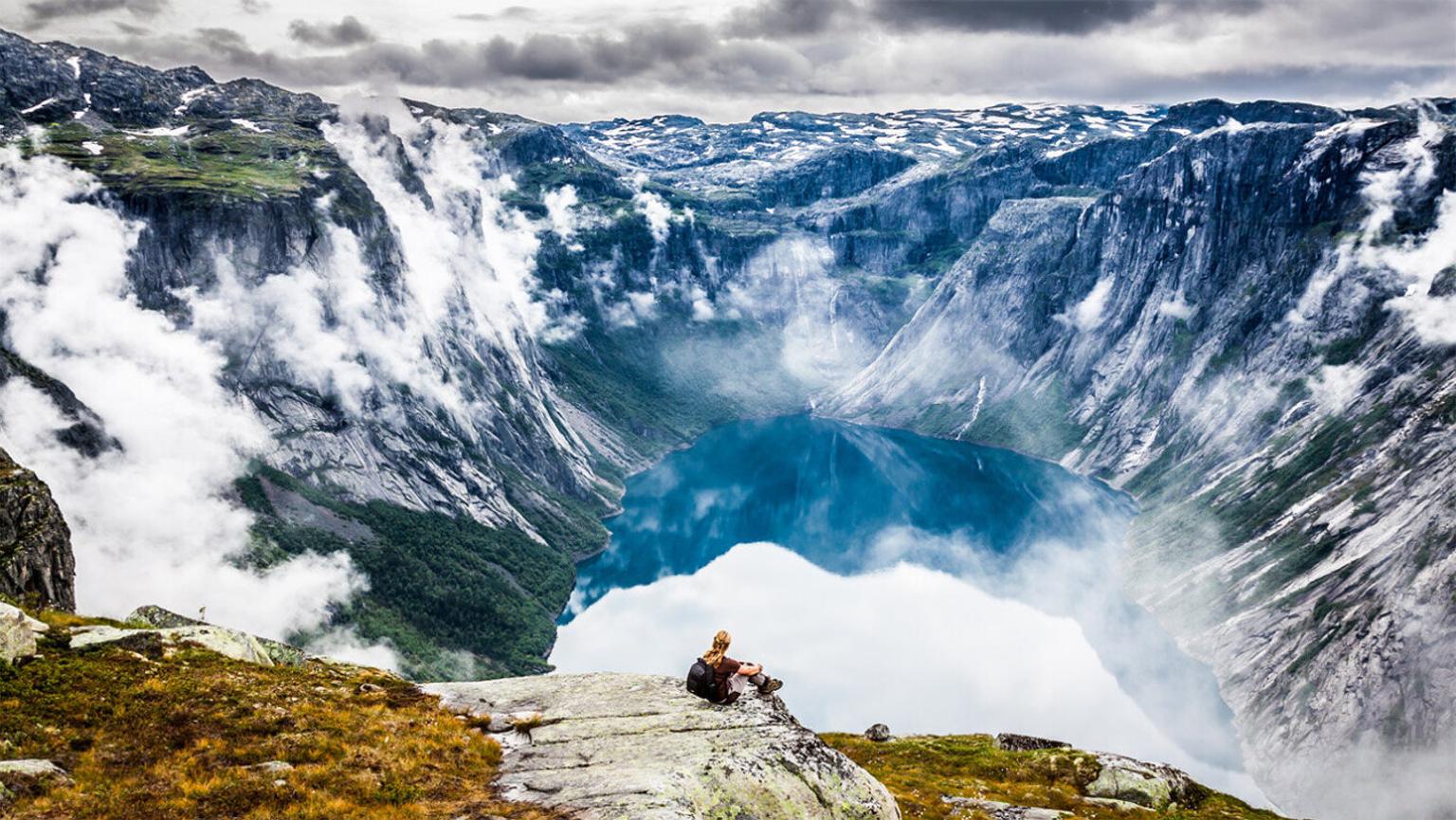 Person looking out over fjord