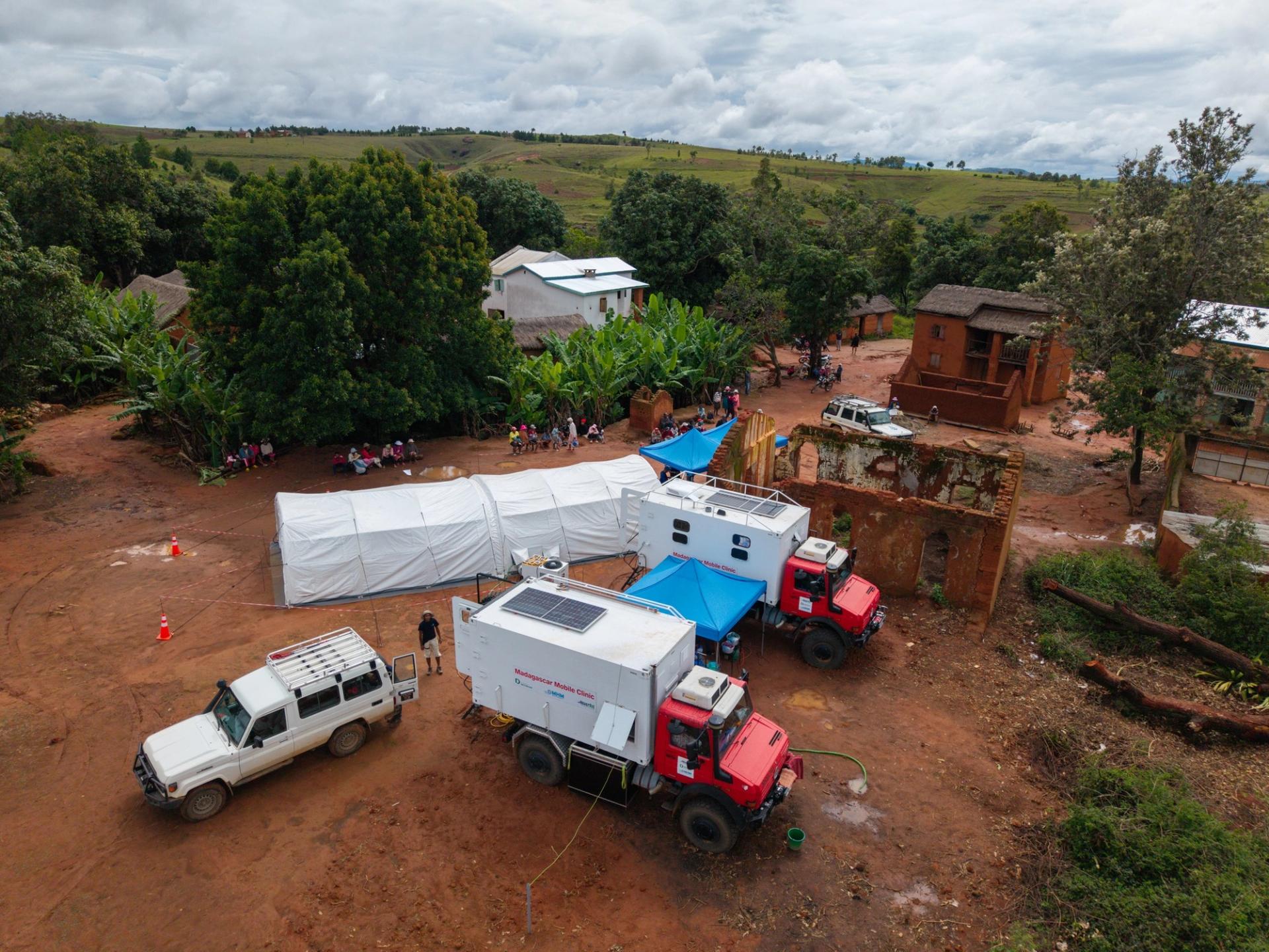 trucks carrying a field hospital of white tents in Madagascar