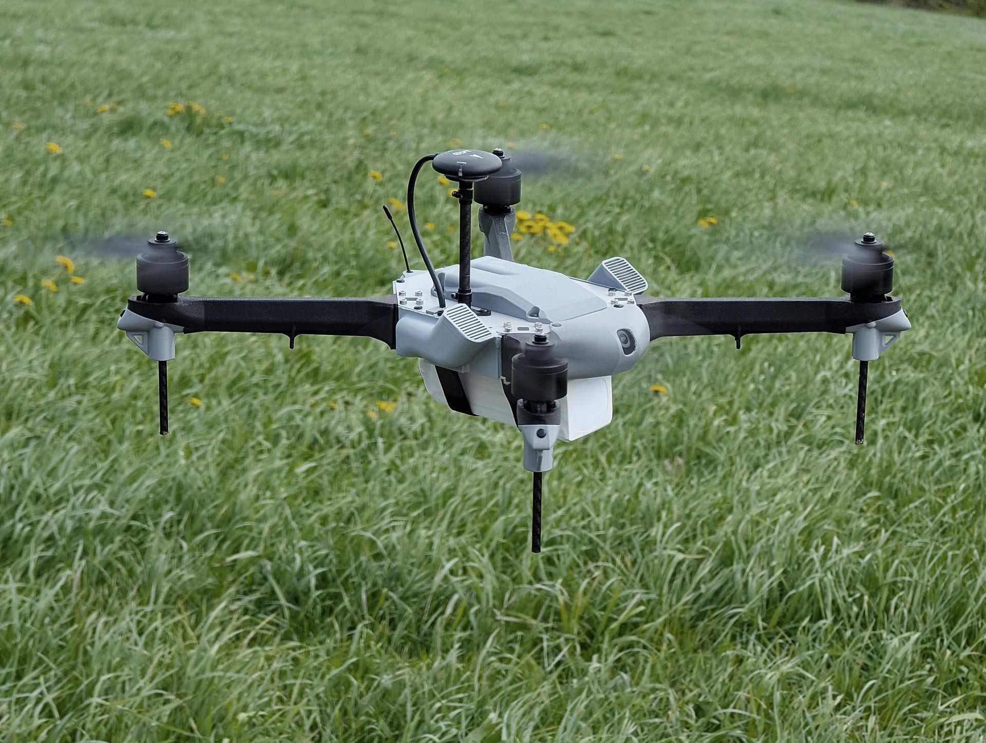Drone taking off from the grass.
