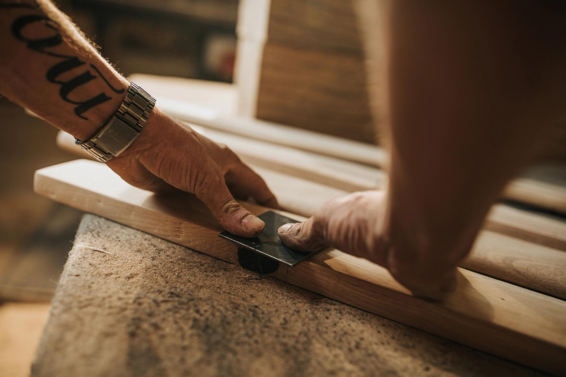 Man placing a stamp on a wooden plank