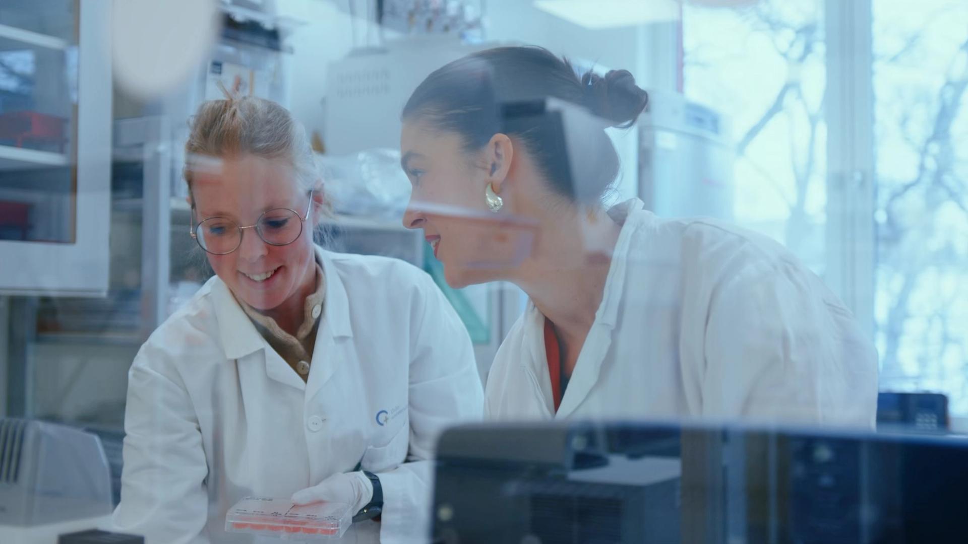 Two female researchers looking at test results