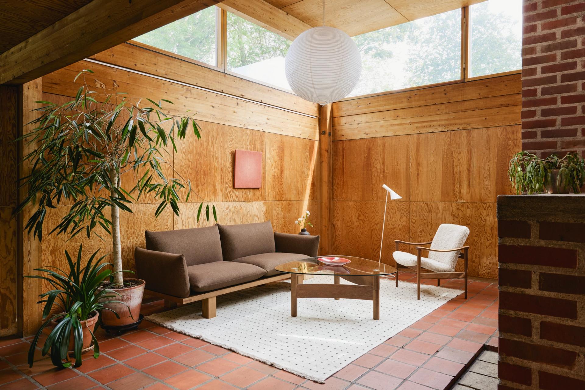 A picture of a living room, with plants and beautiful furniture.