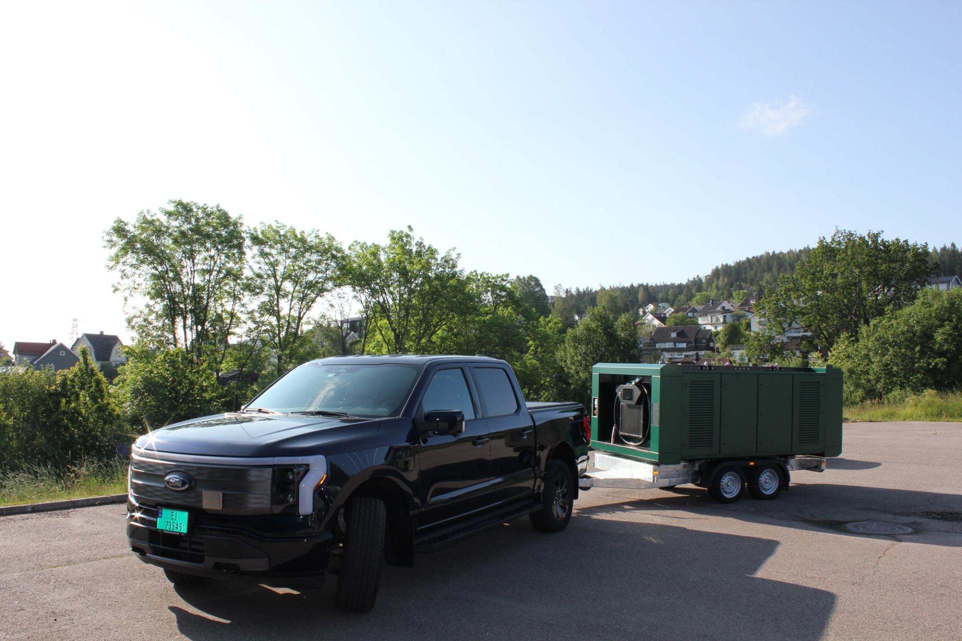 A black car with a battery attached.
