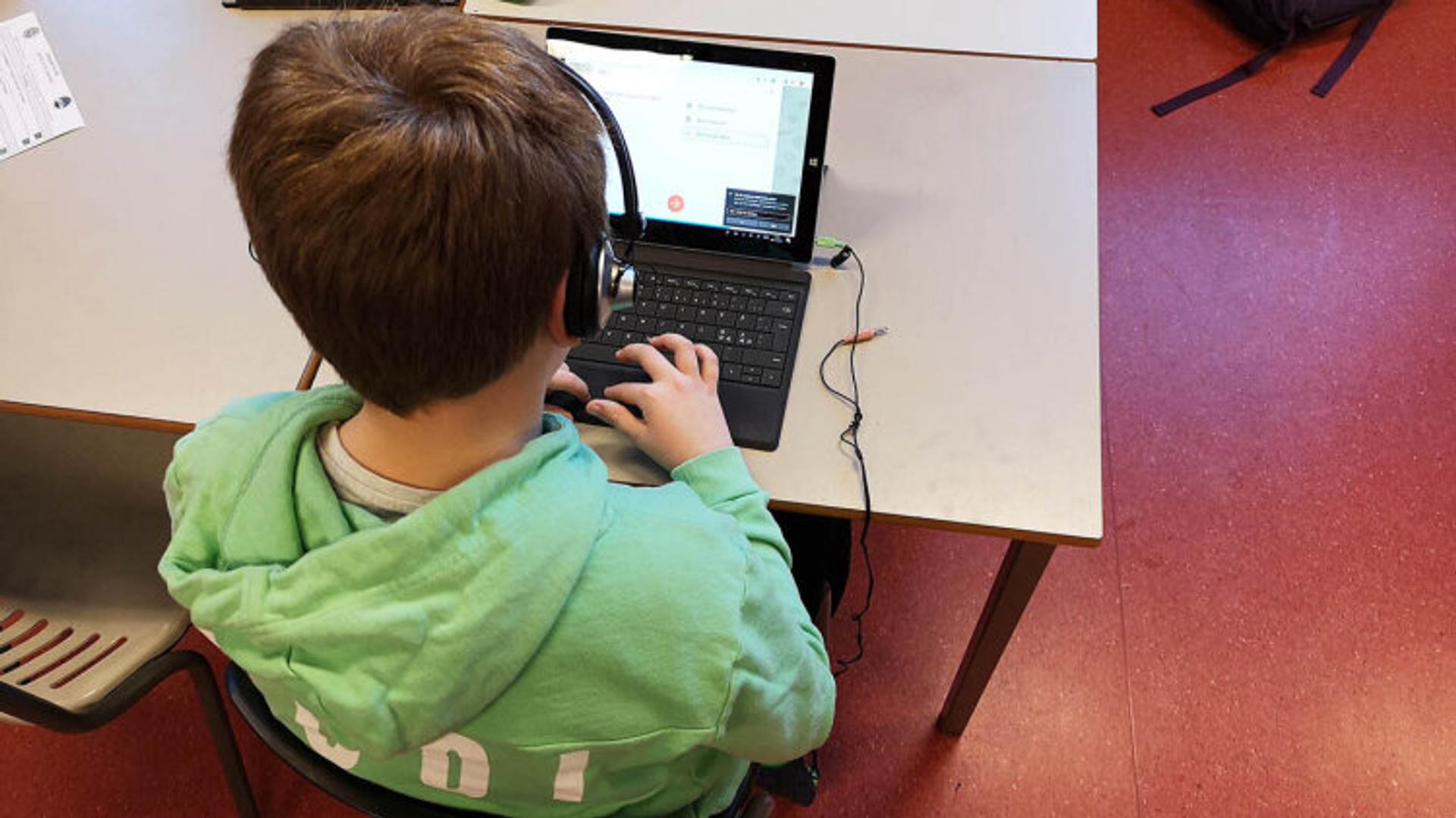 Kid listening to sound on computer