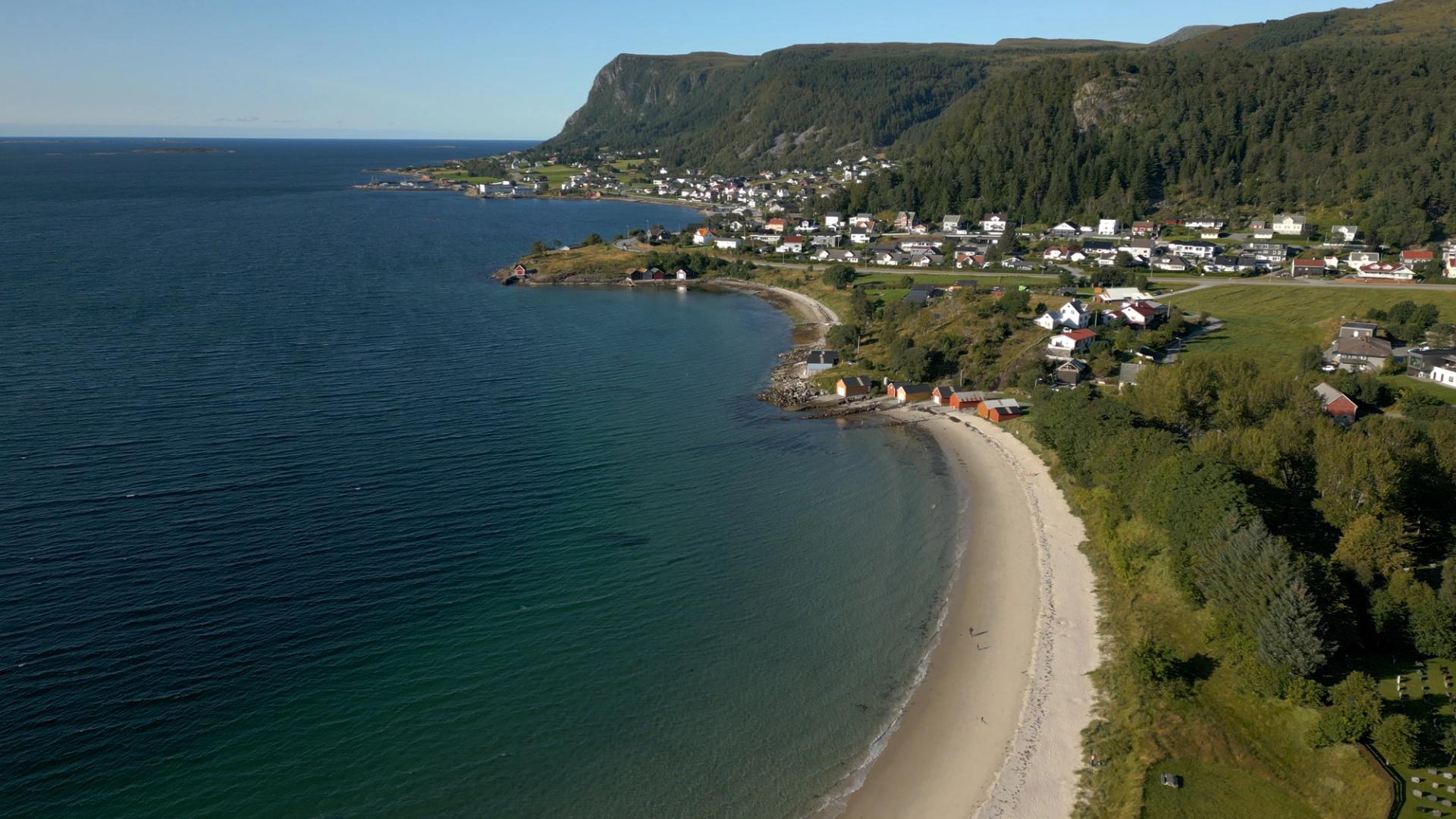 Norwegian coastline with mountains, beach and water