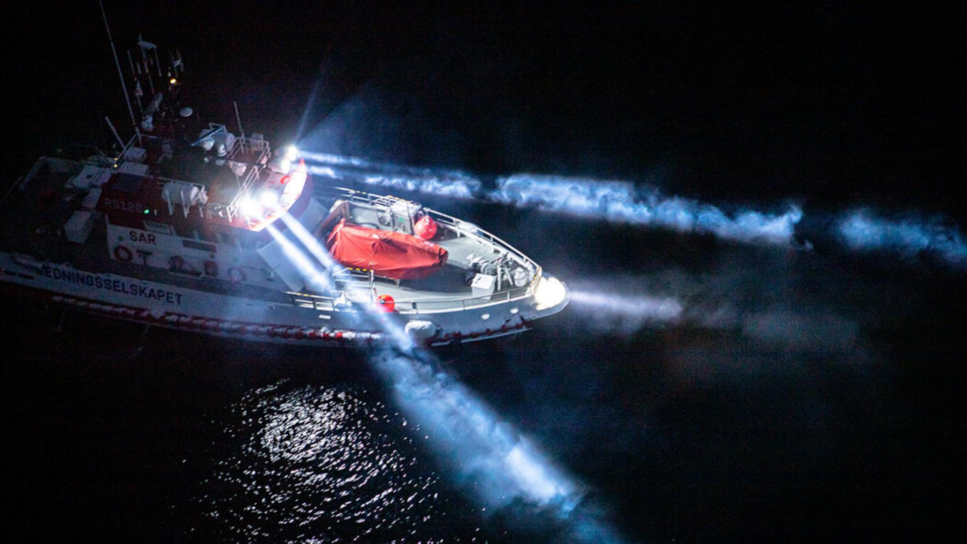 Boat with searchlights on in the dark