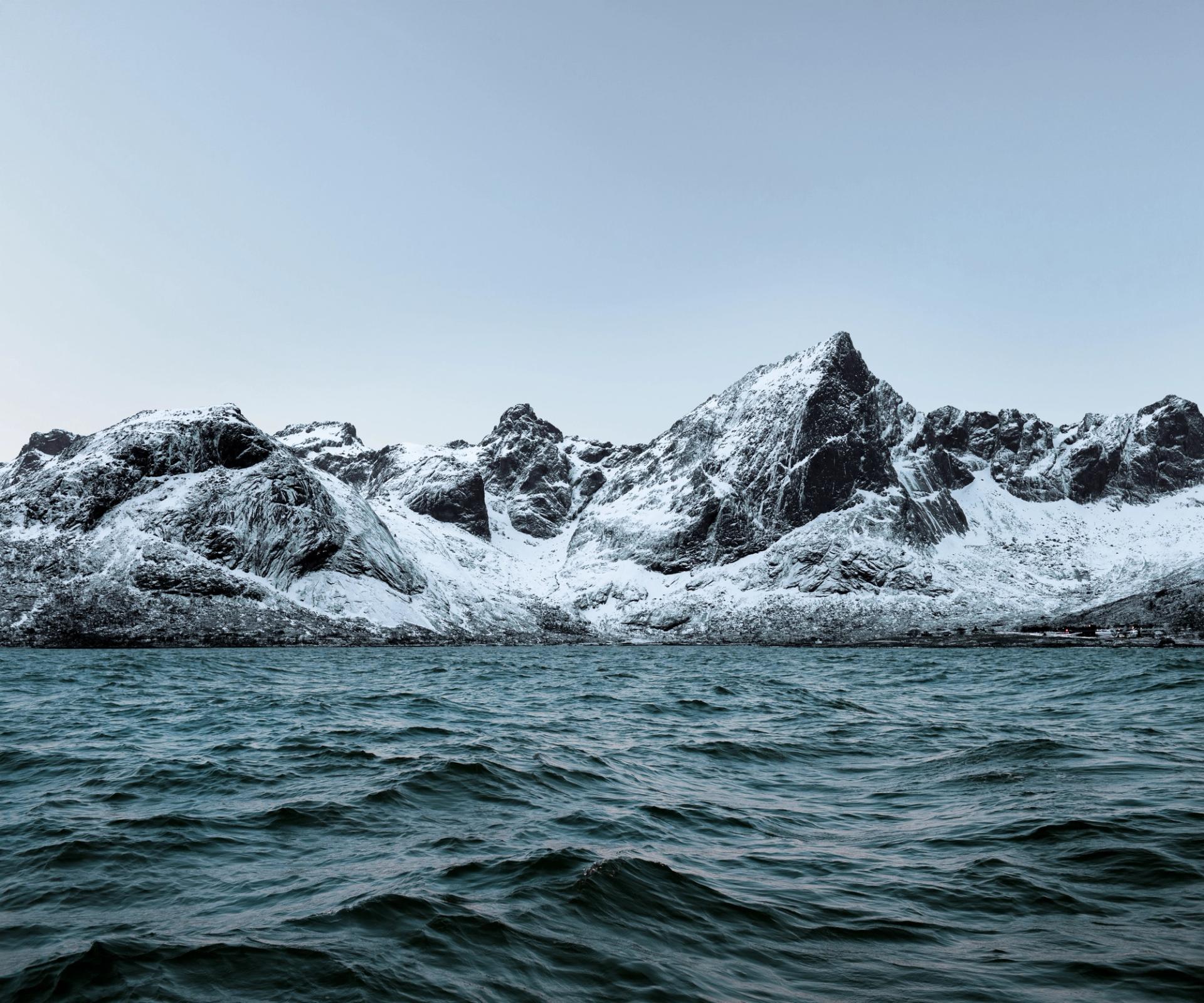 snowy mountains in the choppy Norwegian seas