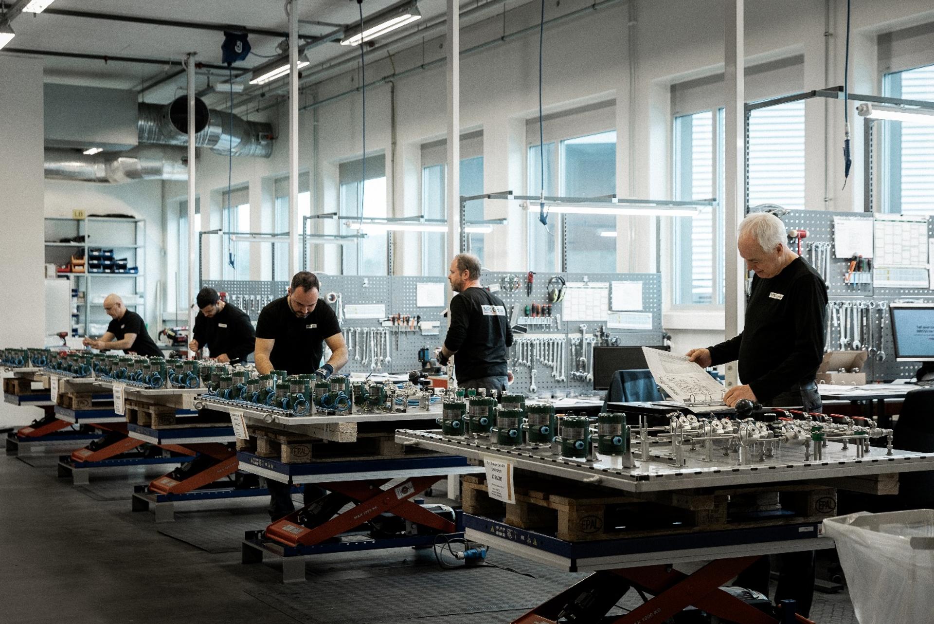 Workers at MRC Global working with instruments