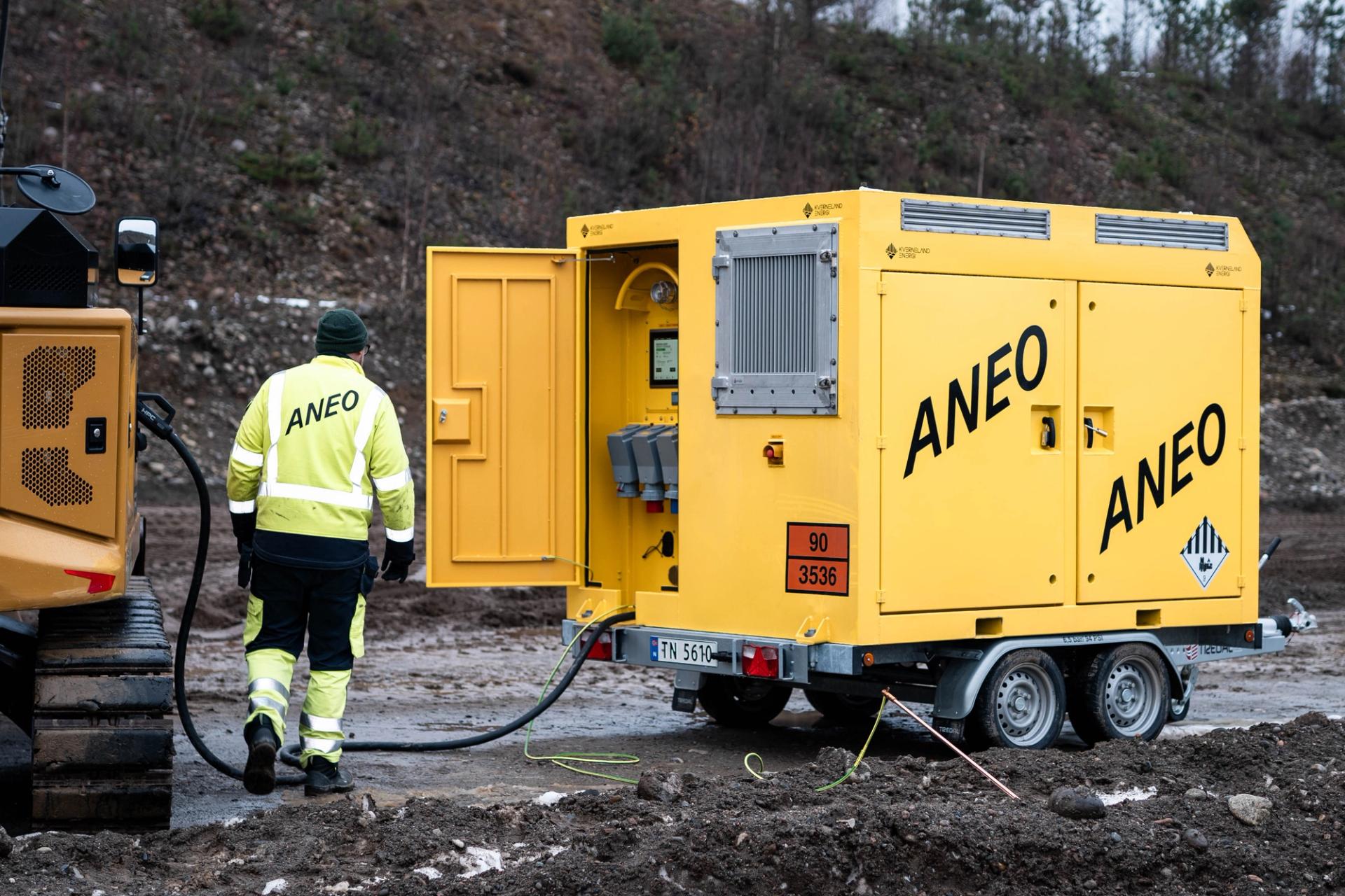 Yellow charging container charging an electric bulldozer