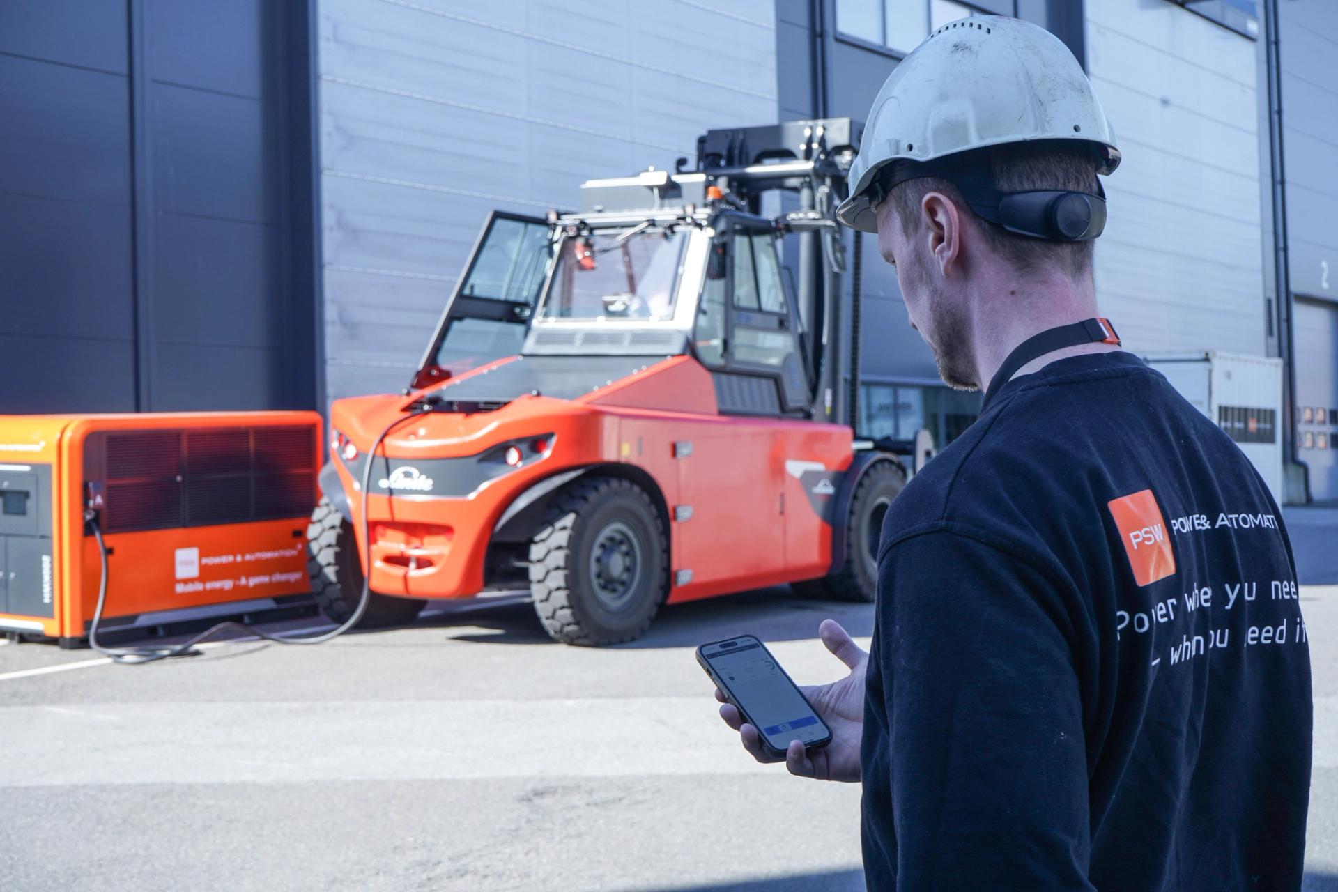 Construction worker looking at a cell phone