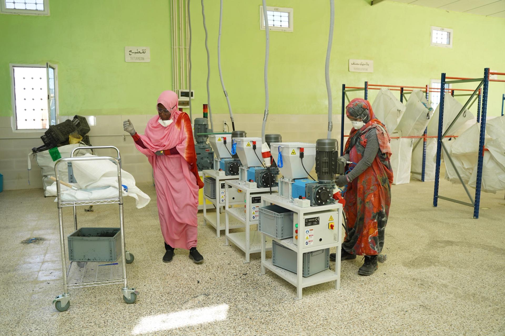 Two women working for UNHCR in a big hall
