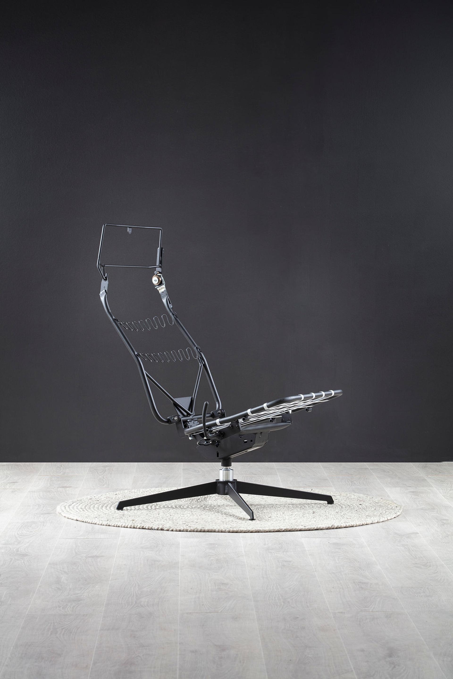 A black and white picture of a steel chair.