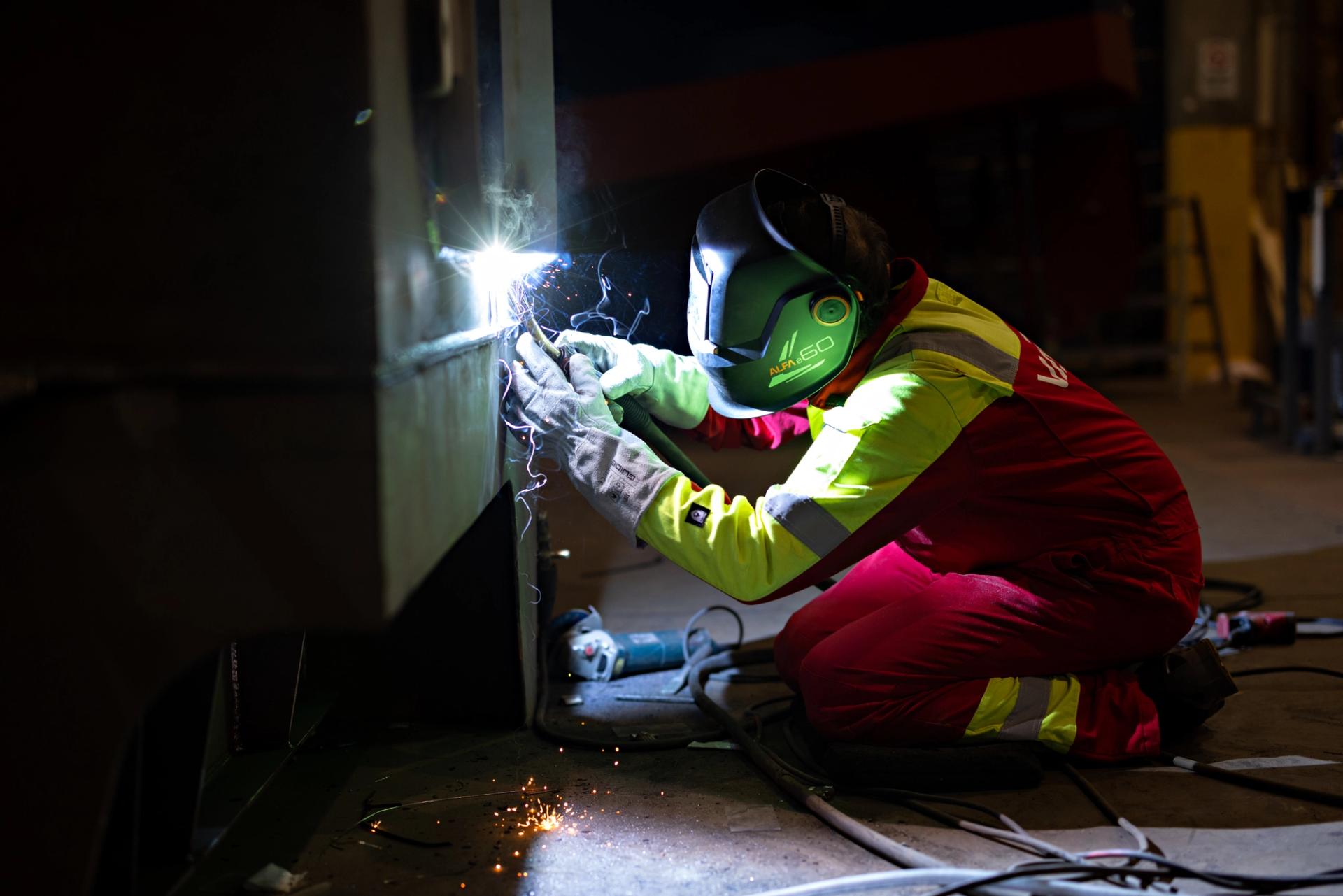 a person in protective gear welding