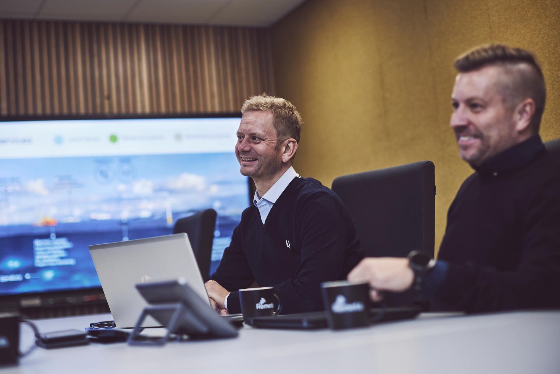 Two men sitting at a boardroom table