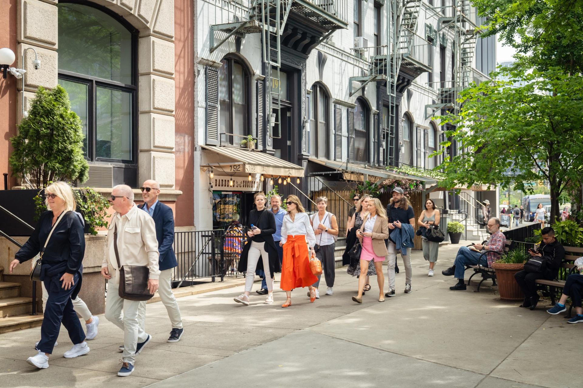 Group of people walking down a street in New York City