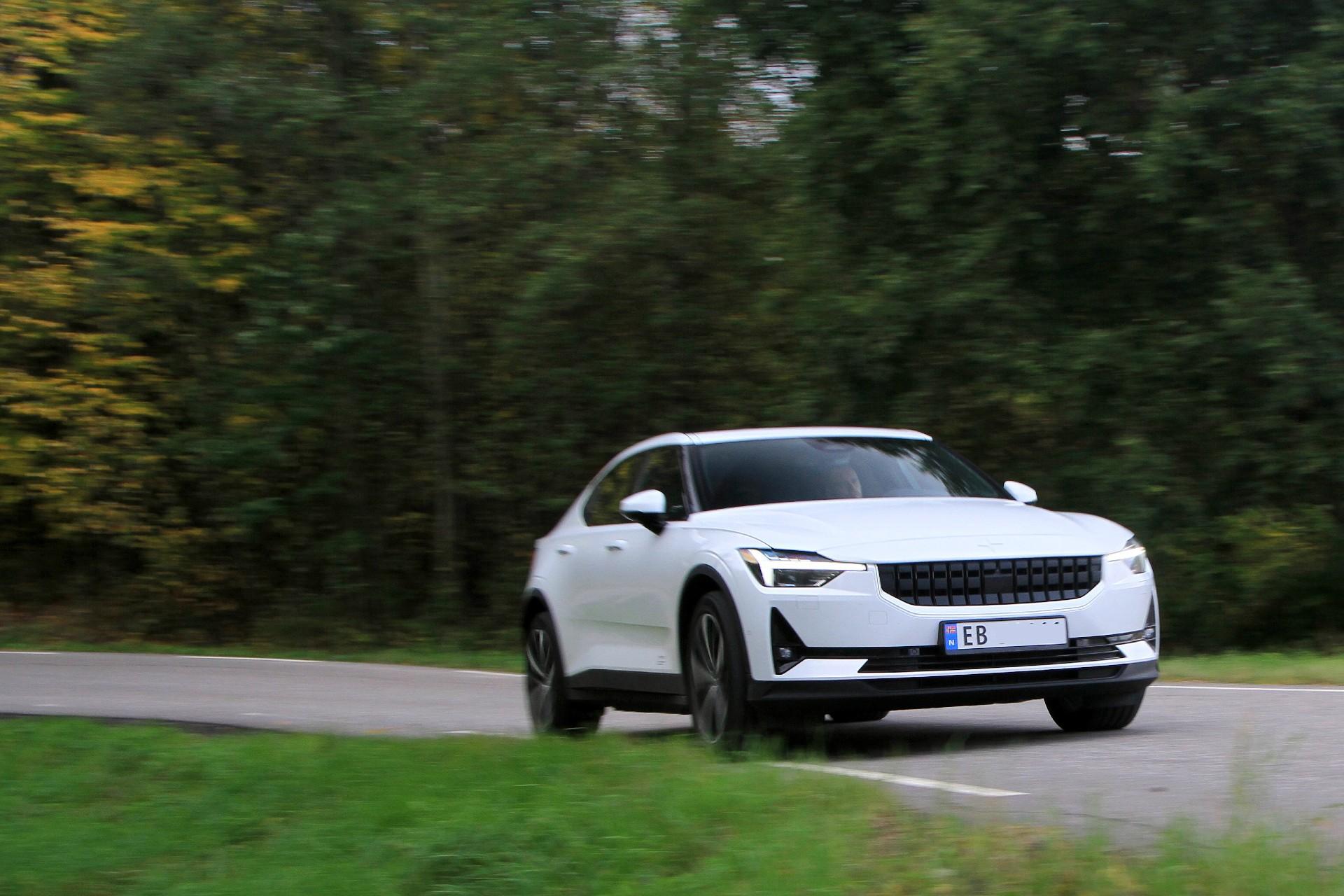 A white electric car driving on Norwegian road