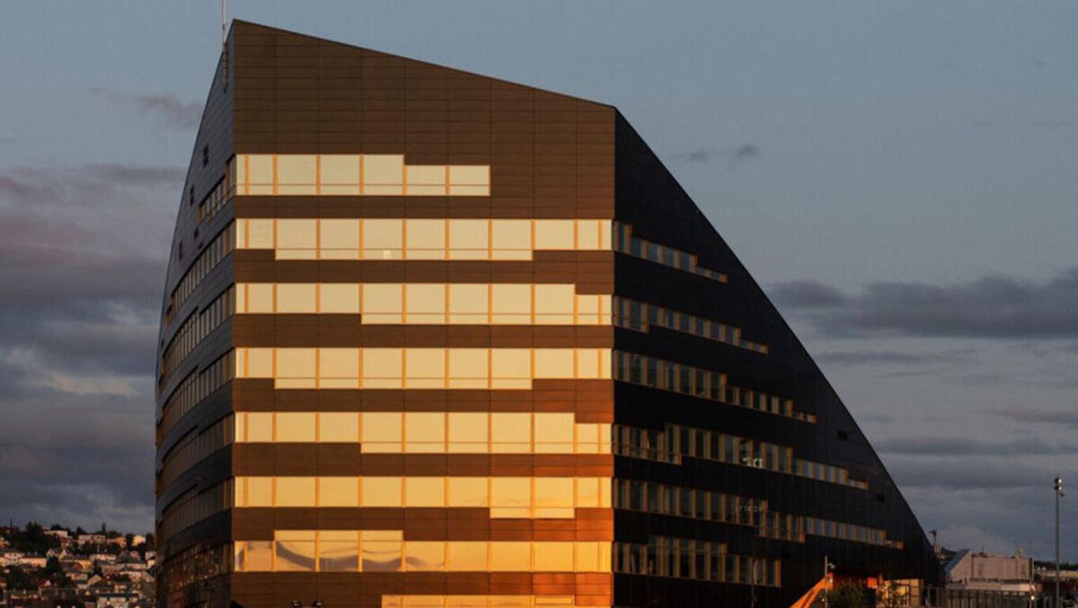 Black building with sun hitting its windows