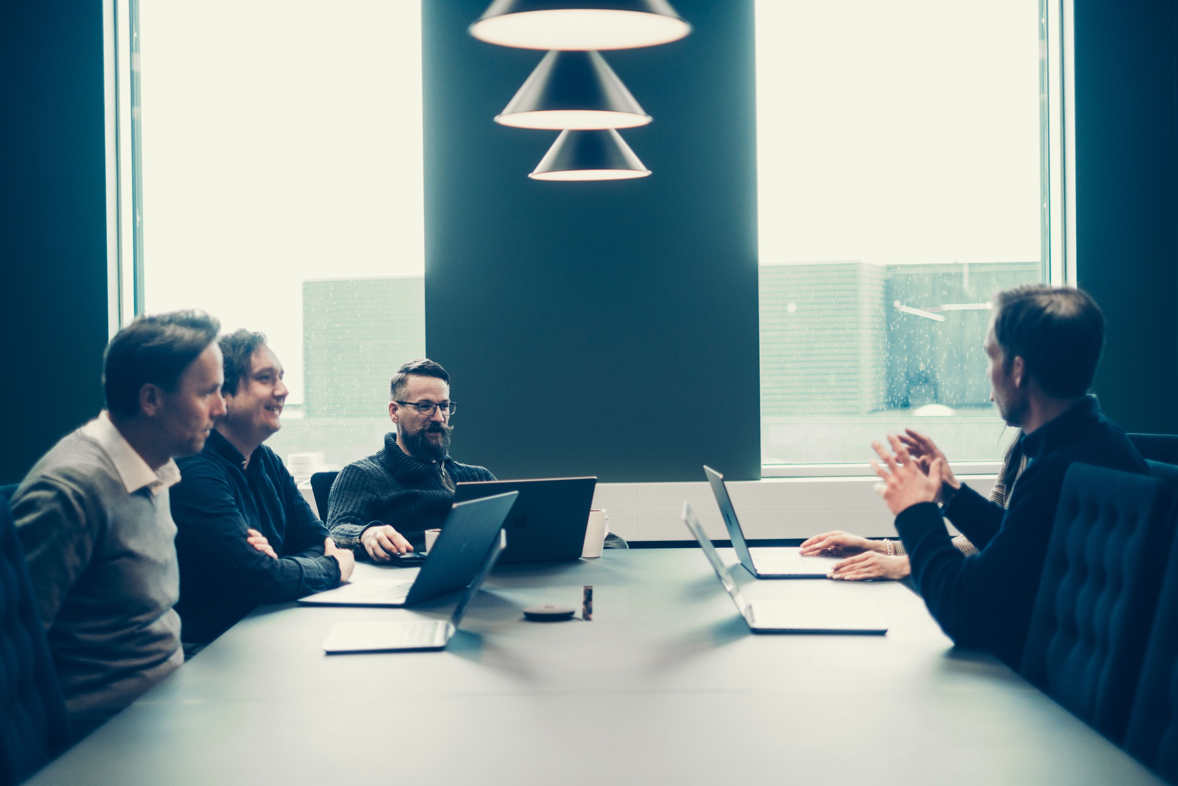 Employees talking in a meeting room.