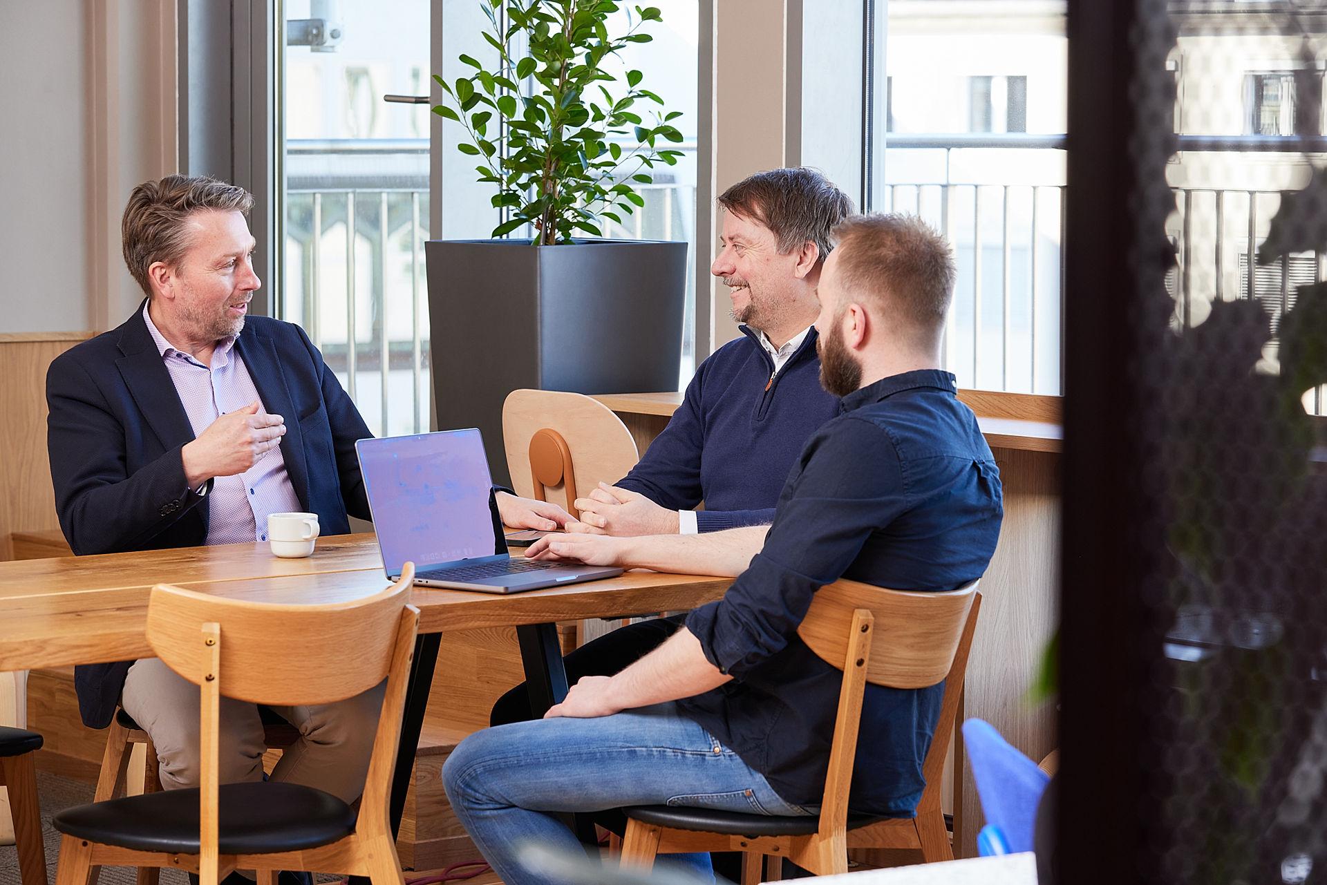 Zaveit employees talking around a table.