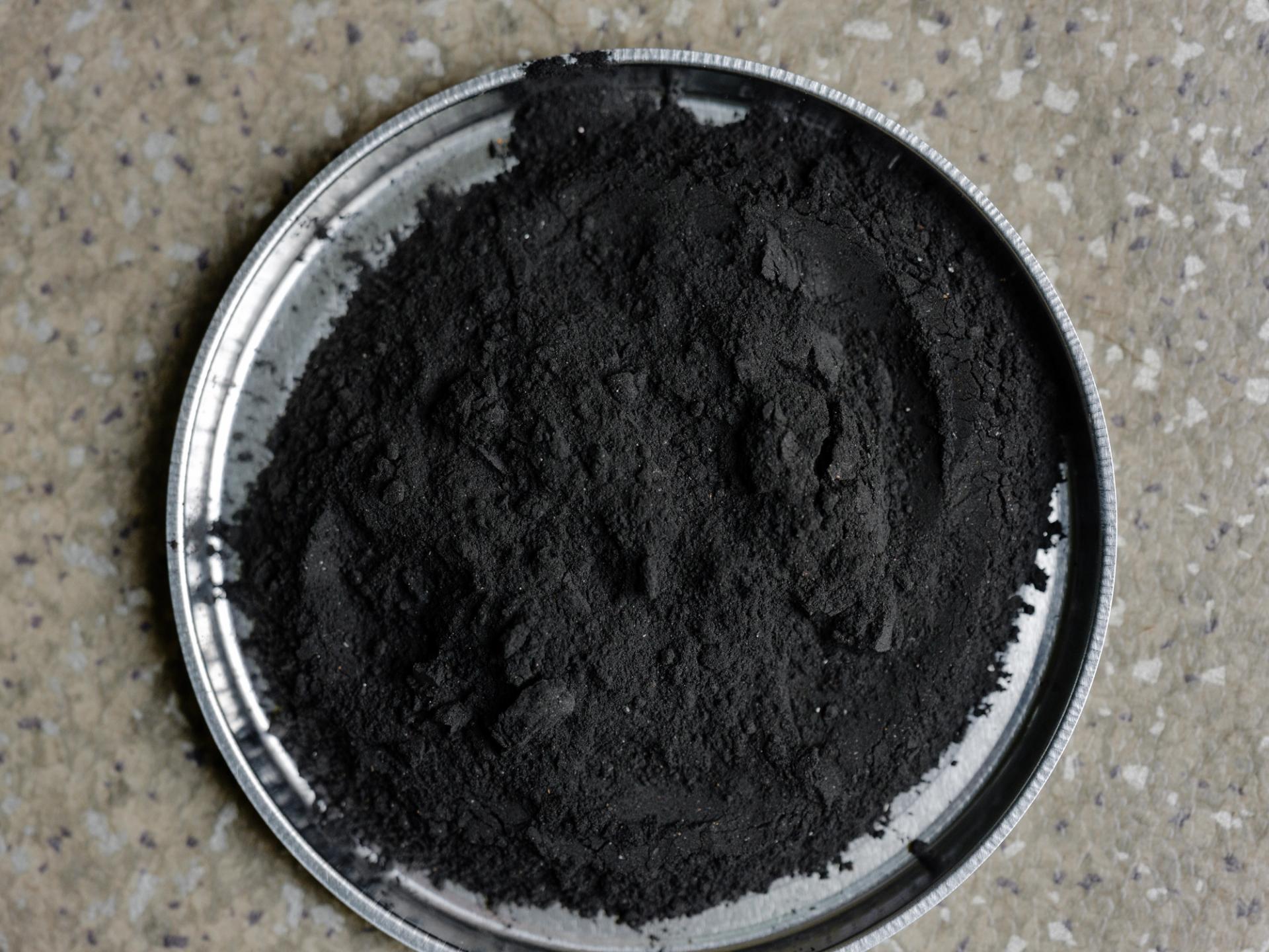 Black powder on a metal plate