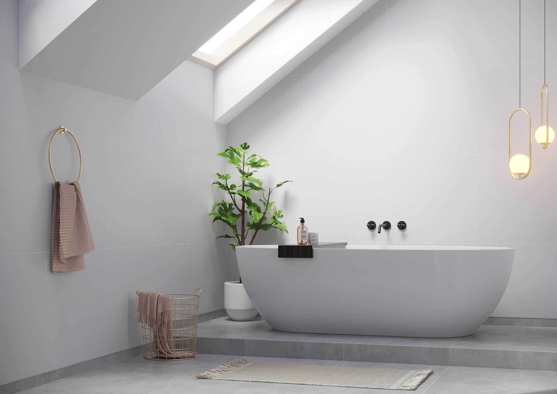 Attic bathroom with grey walls, a freestanding white bathtub on a raised platform, black wall-mounted taps and a sloped skylight.
